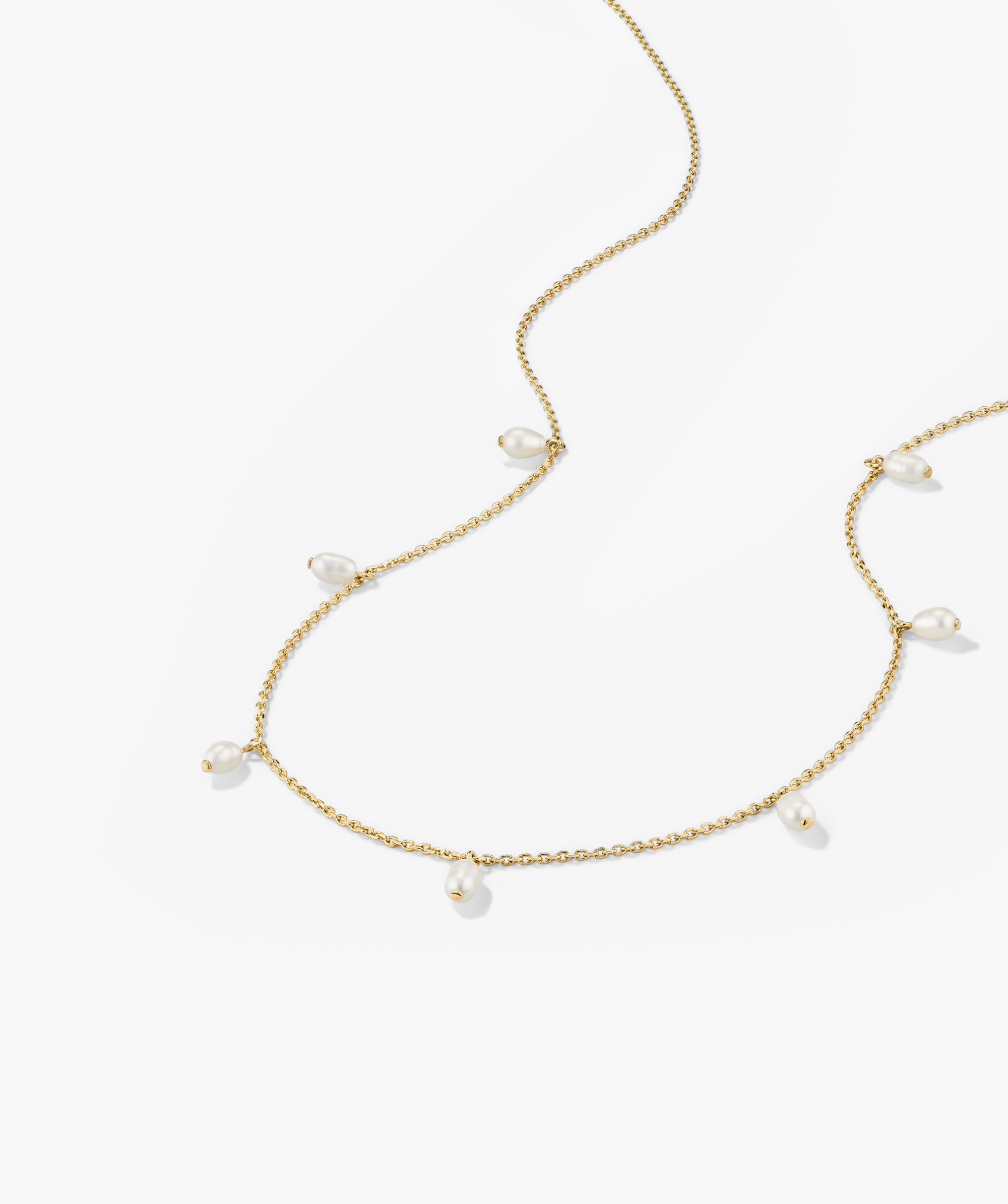Tiny Pearl Station Necklace: An 18k gold vermeil chain adorned with spaced freshwater pearls, finely handcrafted to accentuate minimalist elegance.