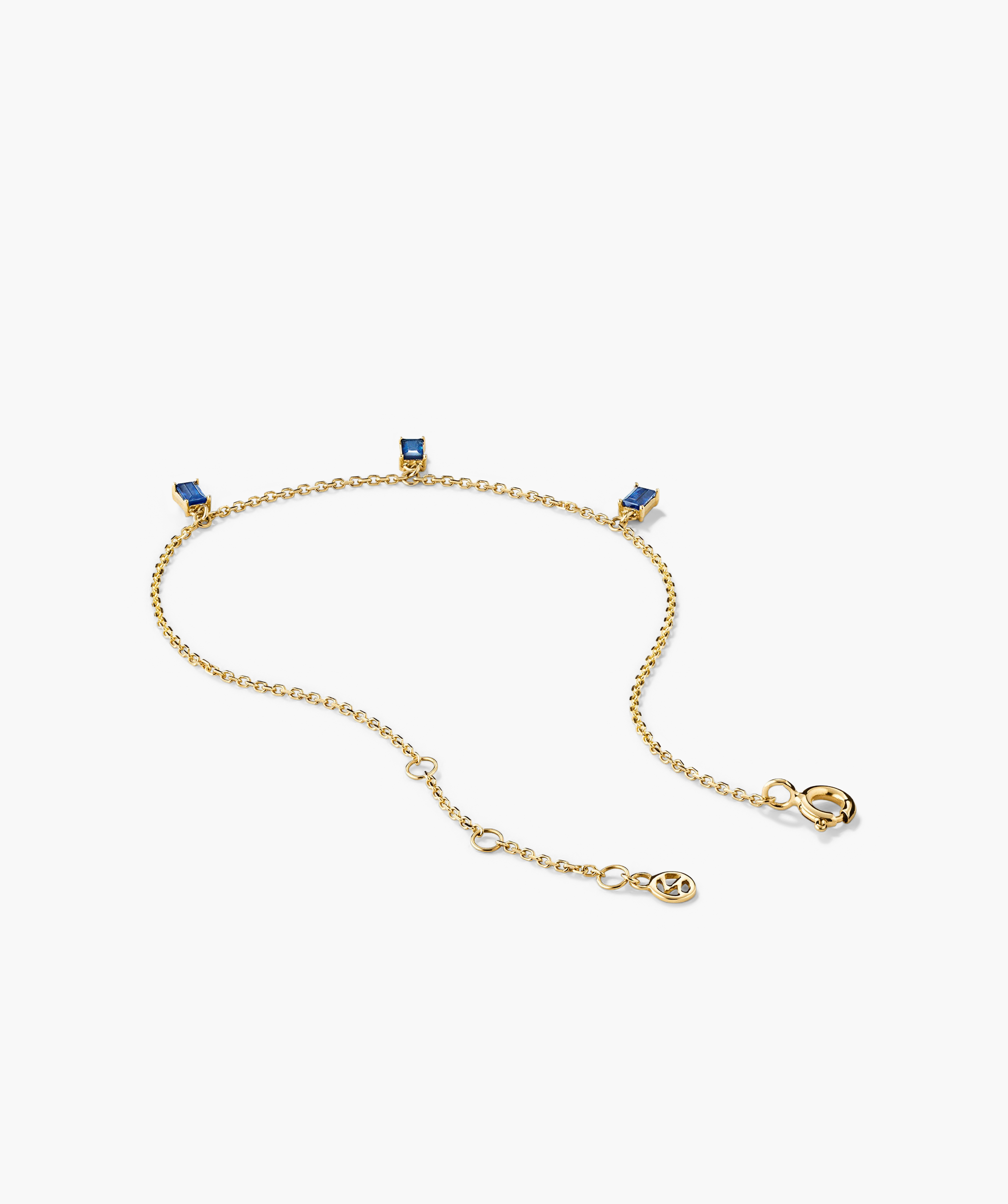 Baguette Gemstone Bracelet featuring a gold chain with blue stones and a prominent blue square gem. Perfect for creating standout jewelry stacks.