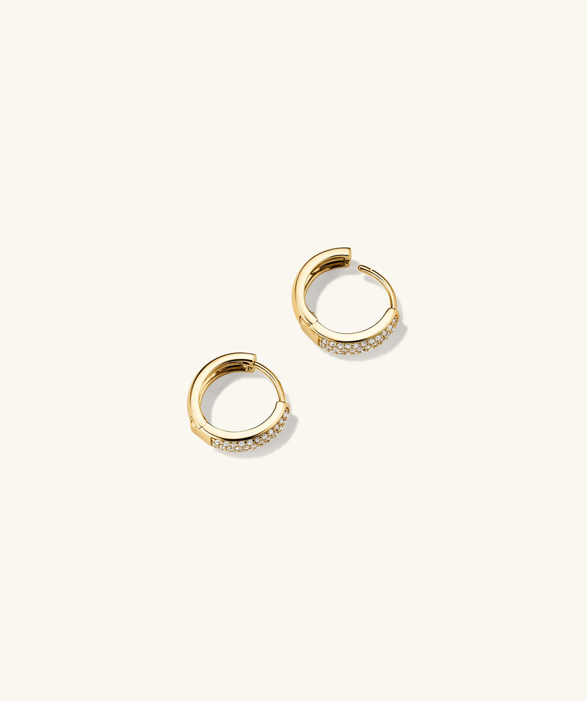 Bold PavÃ© Diamond Huggie Hoops: A pair of 14k solid gold hoop earrings featuring pavÃ©-set, responsibly sourced diamonds, handcrafted for a sparkling, elegant look.