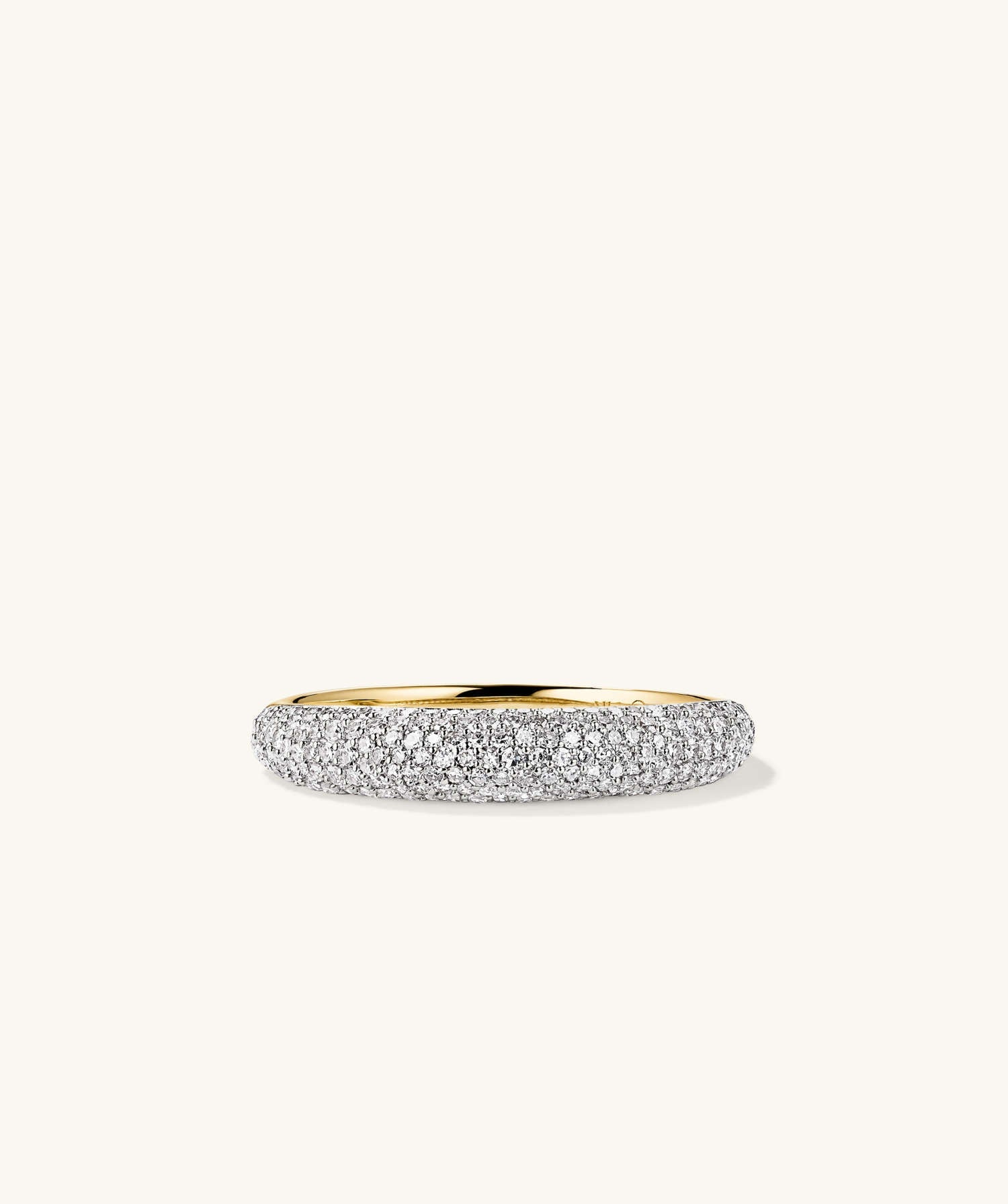 PavÃ© Diamond Thin DÃ´me Ring: A close-up of a handcrafted 14k gold ring adorned with numerous sparkling diamonds, showcasing intricate detailing and luxurious shine.