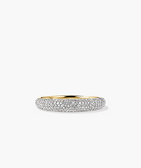 PavÃ© Diamond Thin DÃ´me Ring: A close-up of a handcrafted 14k gold ring adorned with numerous sparkling diamonds, showcasing intricate detailing and luxurious shine.
