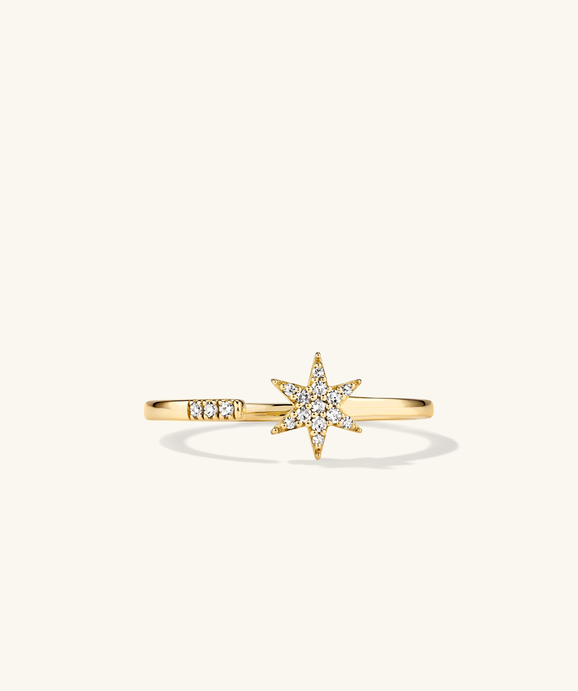 PavÃ© Diamond Star Open Ring: A 14k gold ring featuring a star design with pavÃ© diamonds, handcrafted for stacking elegance.