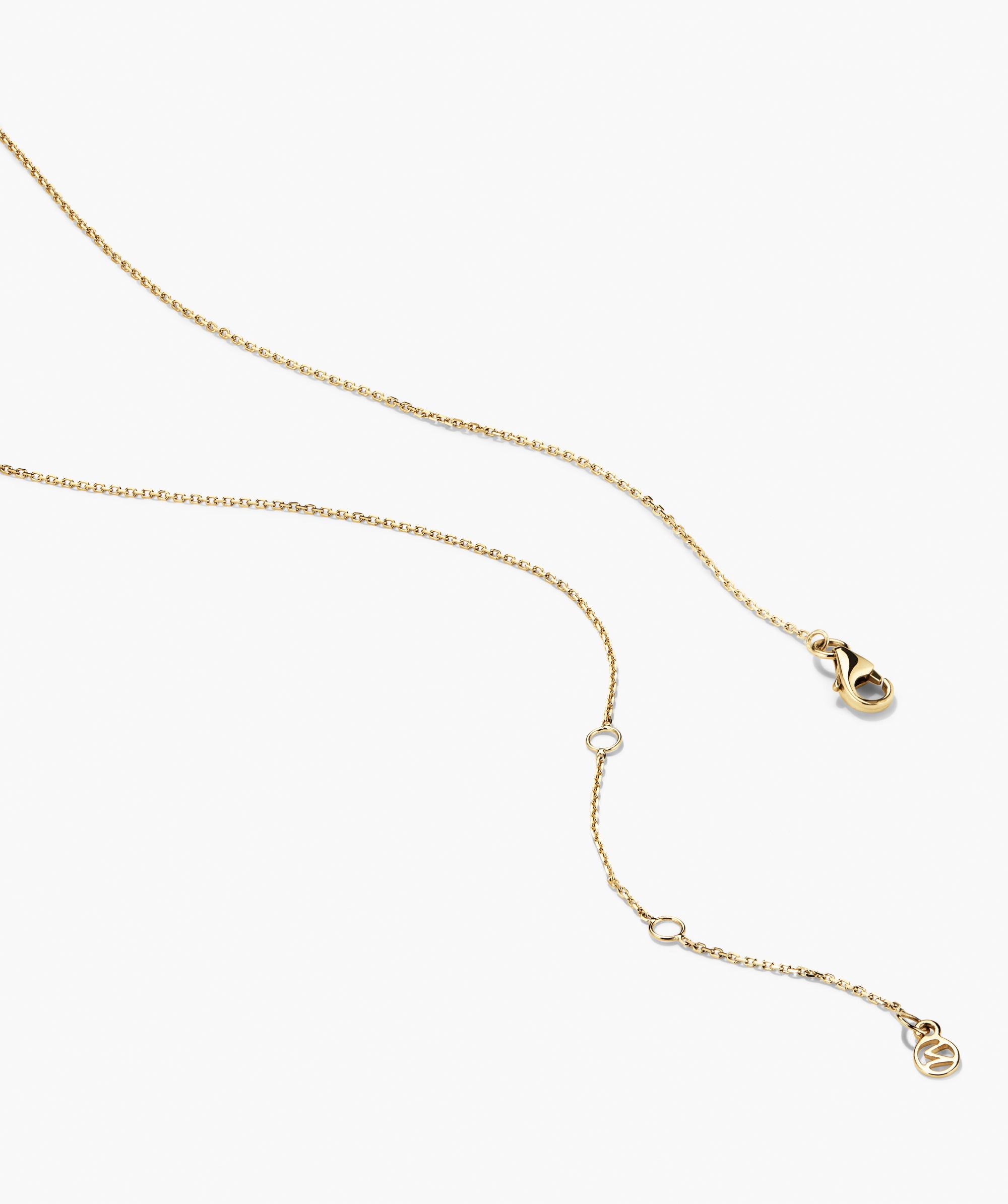 Beverly Necklace: A fine gold-tone chain with a lobster-claw clasp, adjustable ring links, and a circular logo tag, ideal for layering or standalone wear.