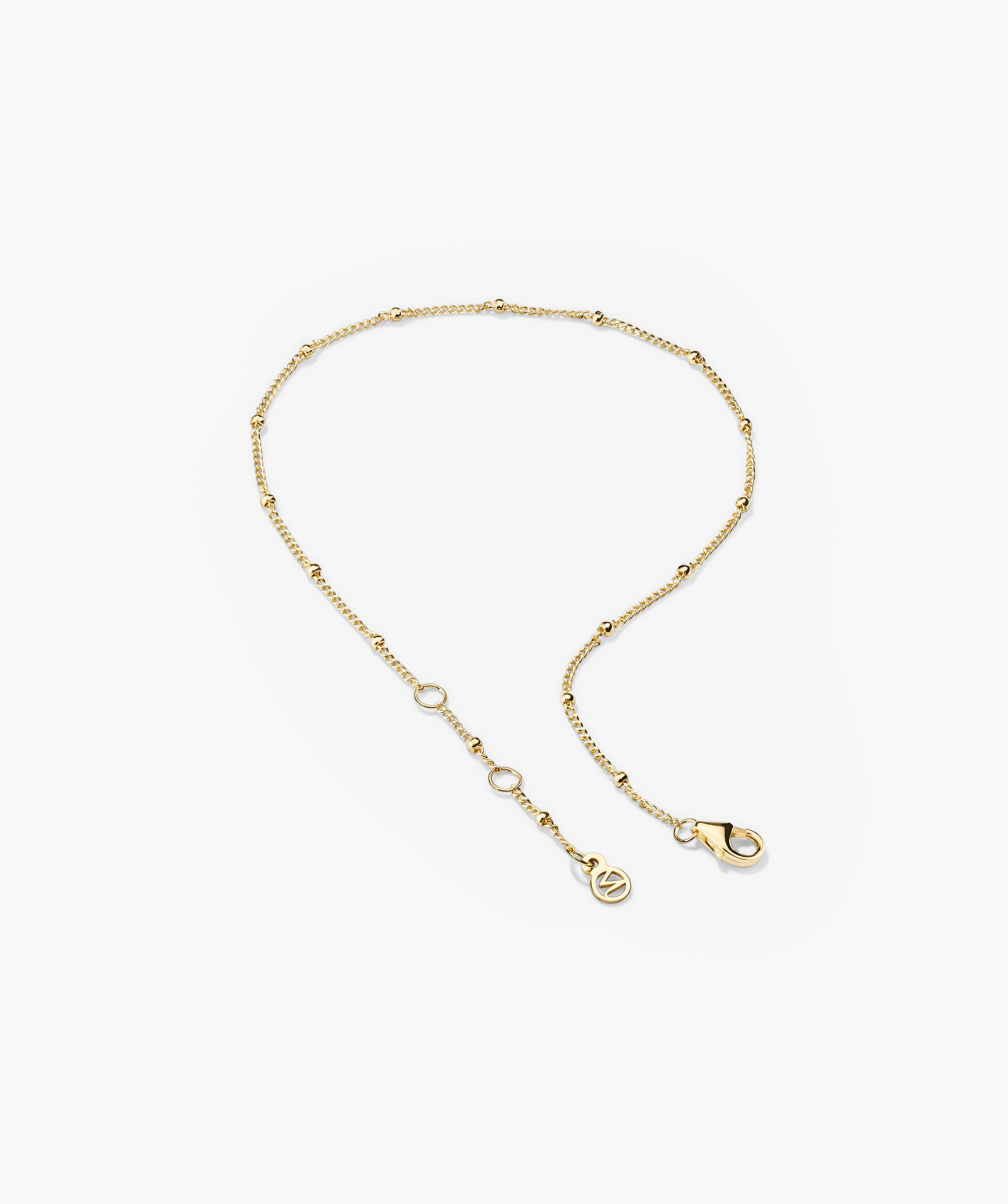 Spheres Bracelet: A minimalist gold chain bracelet with a clasp, featuring small round beads. Versatile for any outfit and occasion.