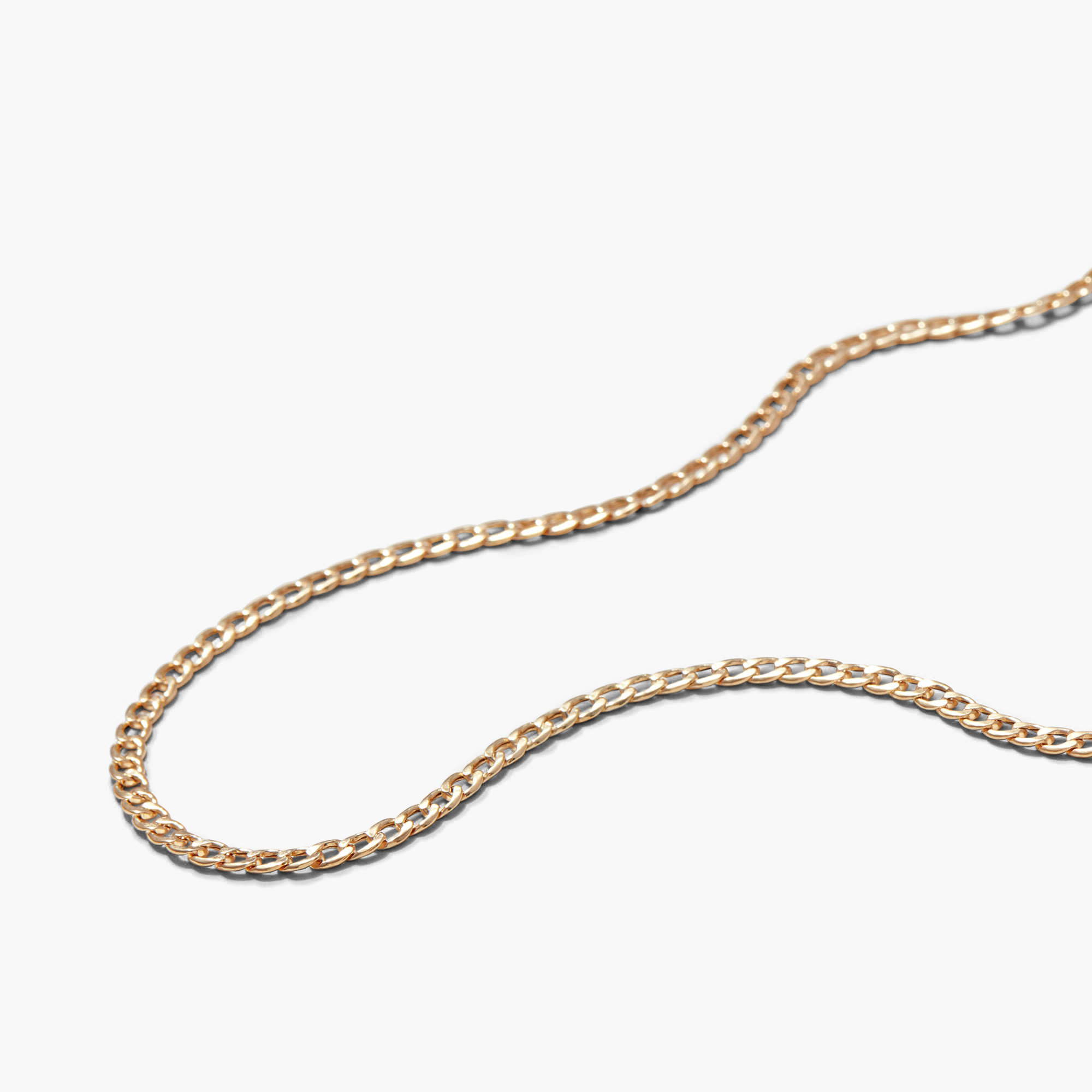 Flat Curb Chain Necklace displayed on a white surface, showcasing its elegant design and fine craftsmanship. Perfect for daily wear and versatile styling.