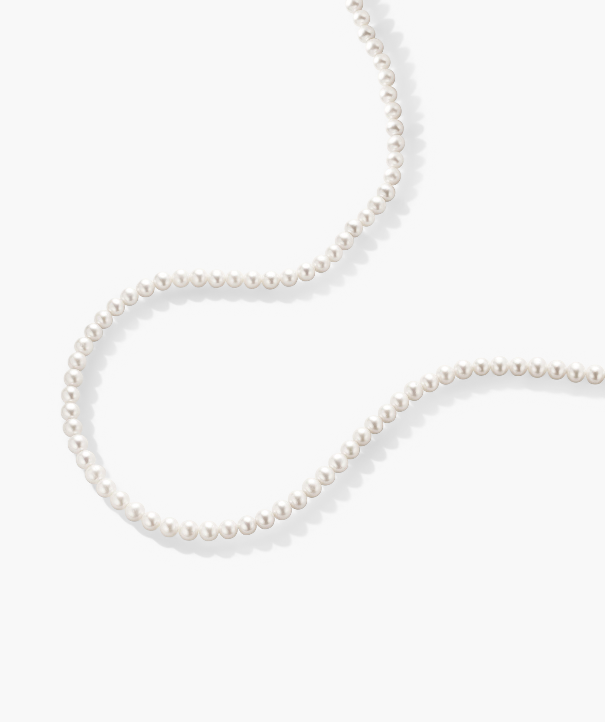 Paradigm Pearl Necklace: A handcrafted string of freshwater pearls with a sterling silver clasp, displayed on a white surface.