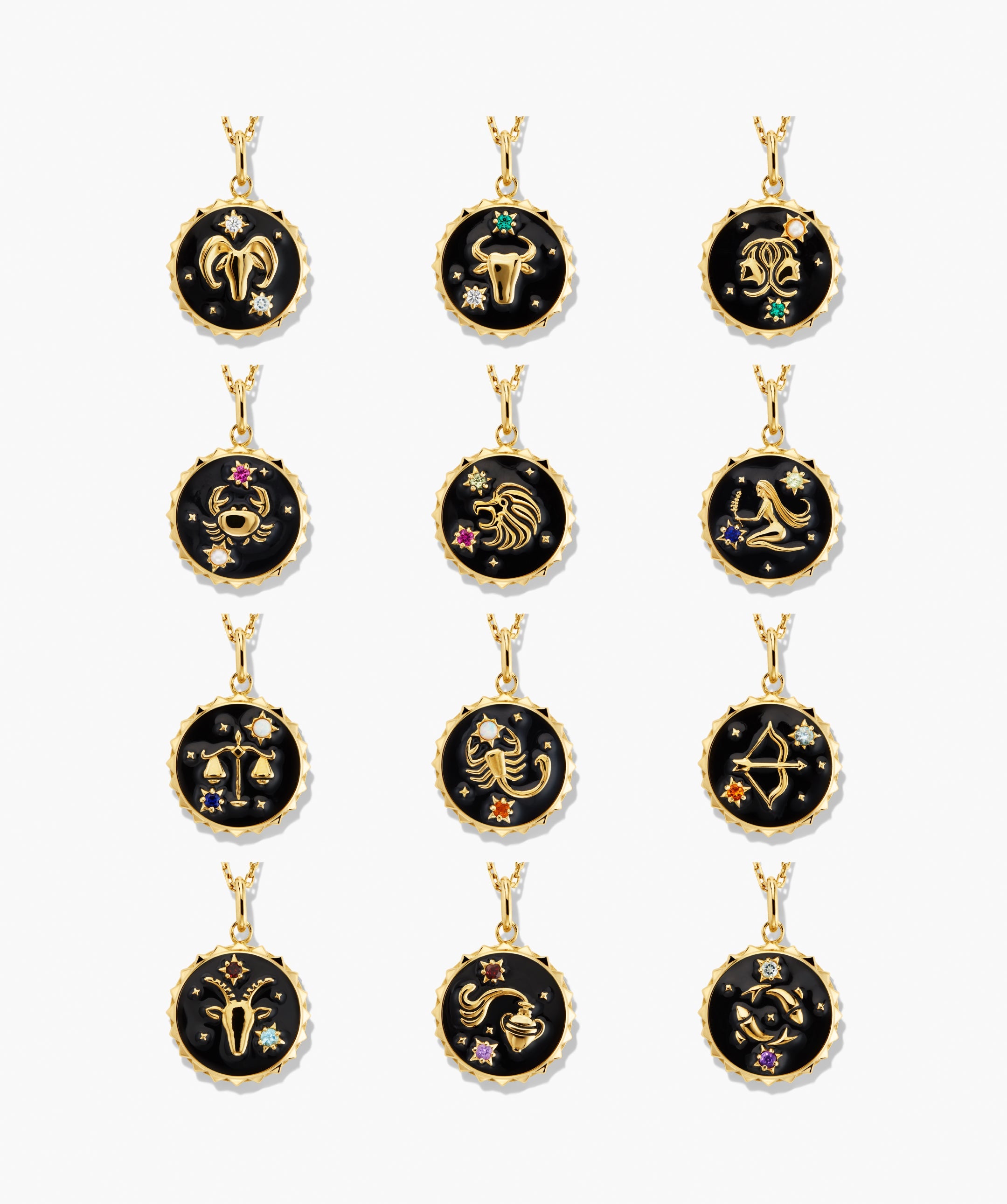 Cosmic Pendant Necklace featuring twelve round pendants with gold zodiac symbols on black enamel, accented with small gemstone stars, representing each astrological sign.