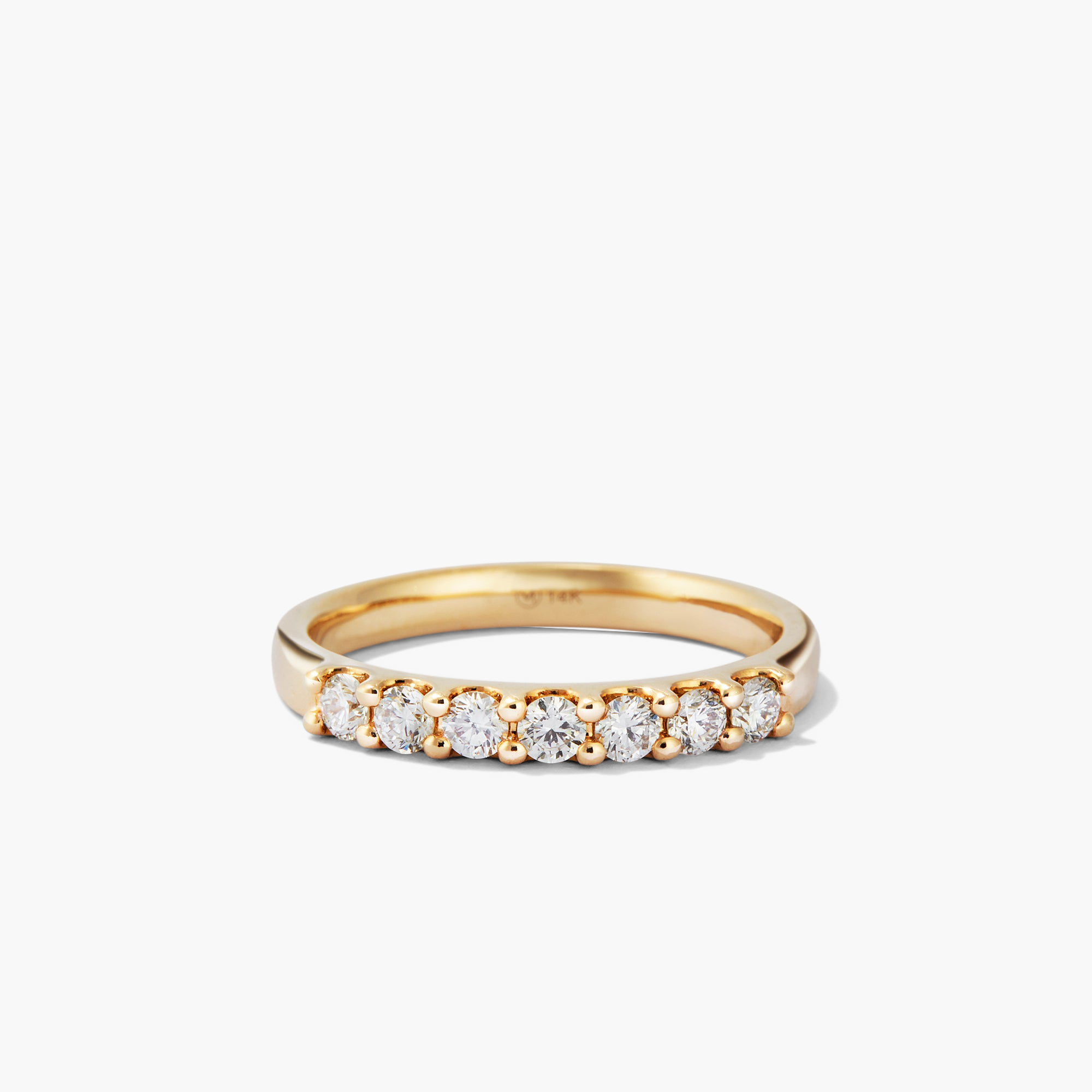 Bold Diamond Half Eternity Ring: a close-up of a 14k gold ring with seven round cut diamonds. Perfect for stacking with the Bold Diamond Eternity Ring.