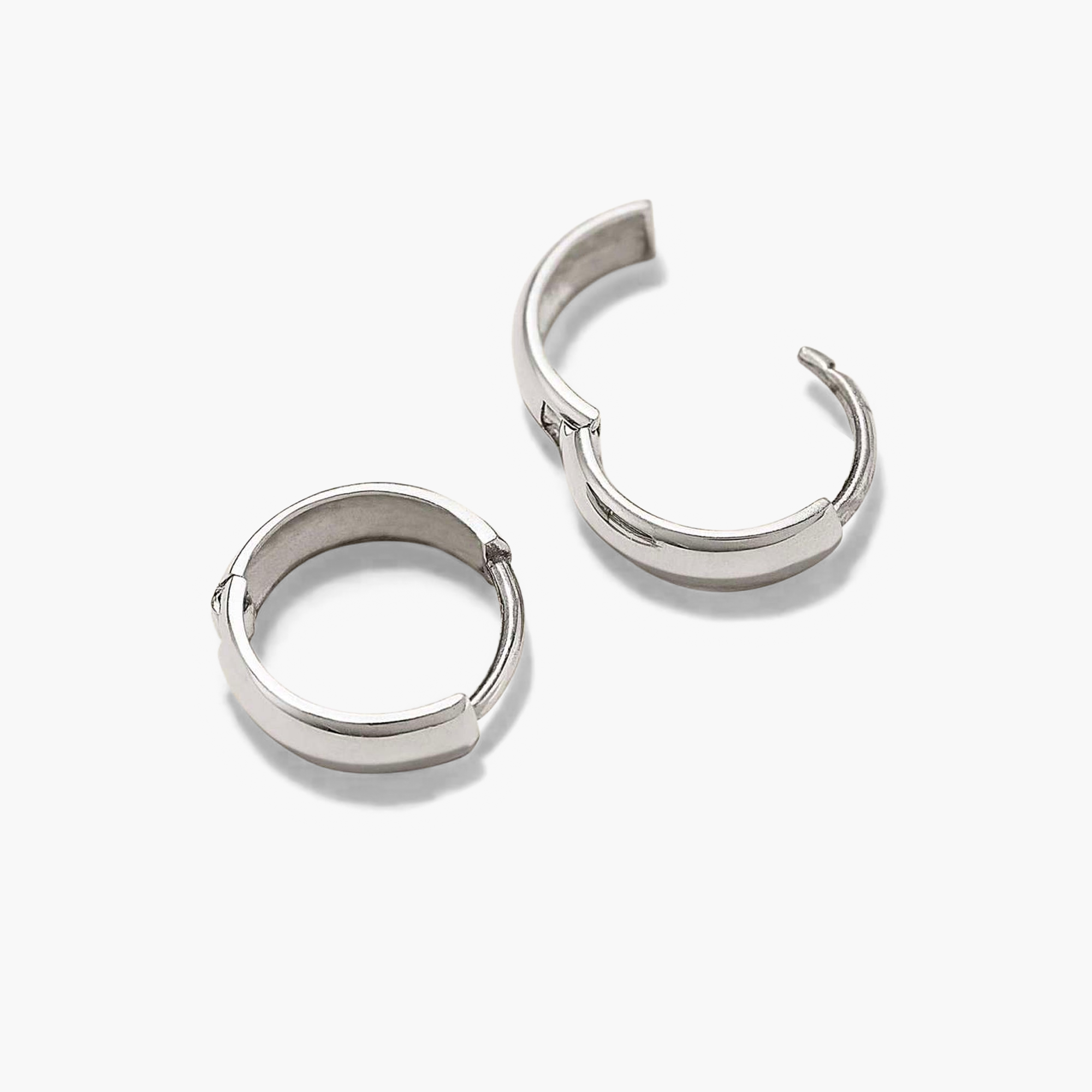 Bold Huggie Hoops: A pair of silver hoop earrings, known for their sleek design and versatility, perfect for elevating any outfit.