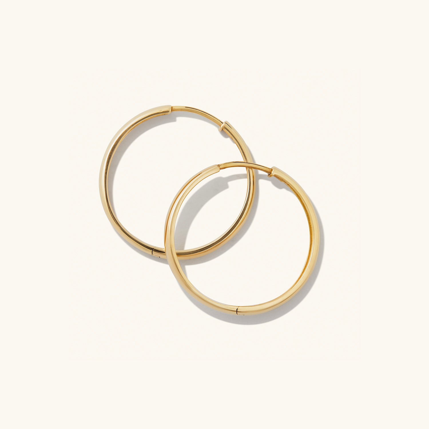 Bold Large Hoops: Handcrafted in recycled 14k solid gold, these statement earrings elevate any outfit with their classic, mood-boosting design.
