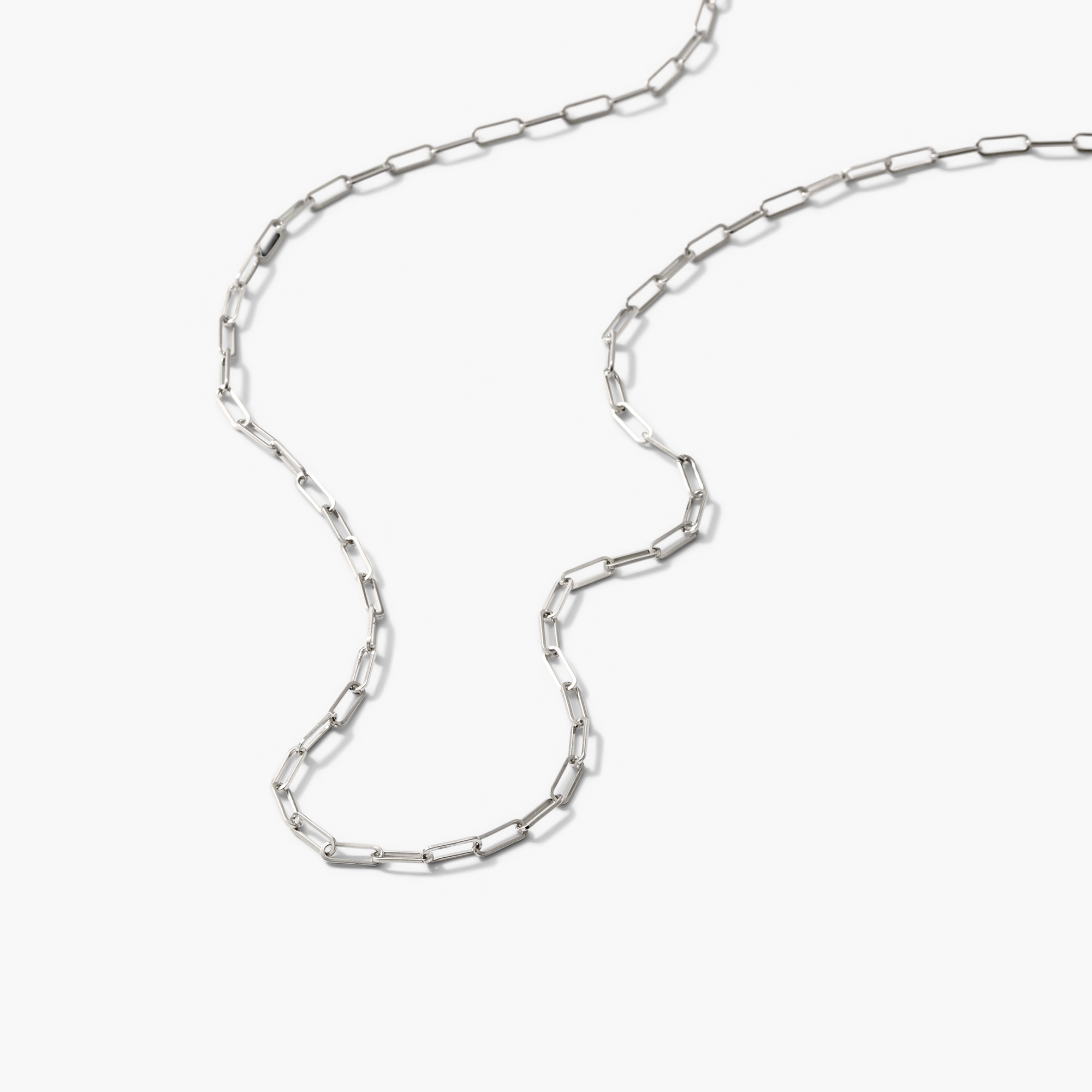 Boyfriend Bold Chain Necklace displayed on a white surface, showcasing its long, silver chain design. Perfect for complementing a raw, loose denim look.