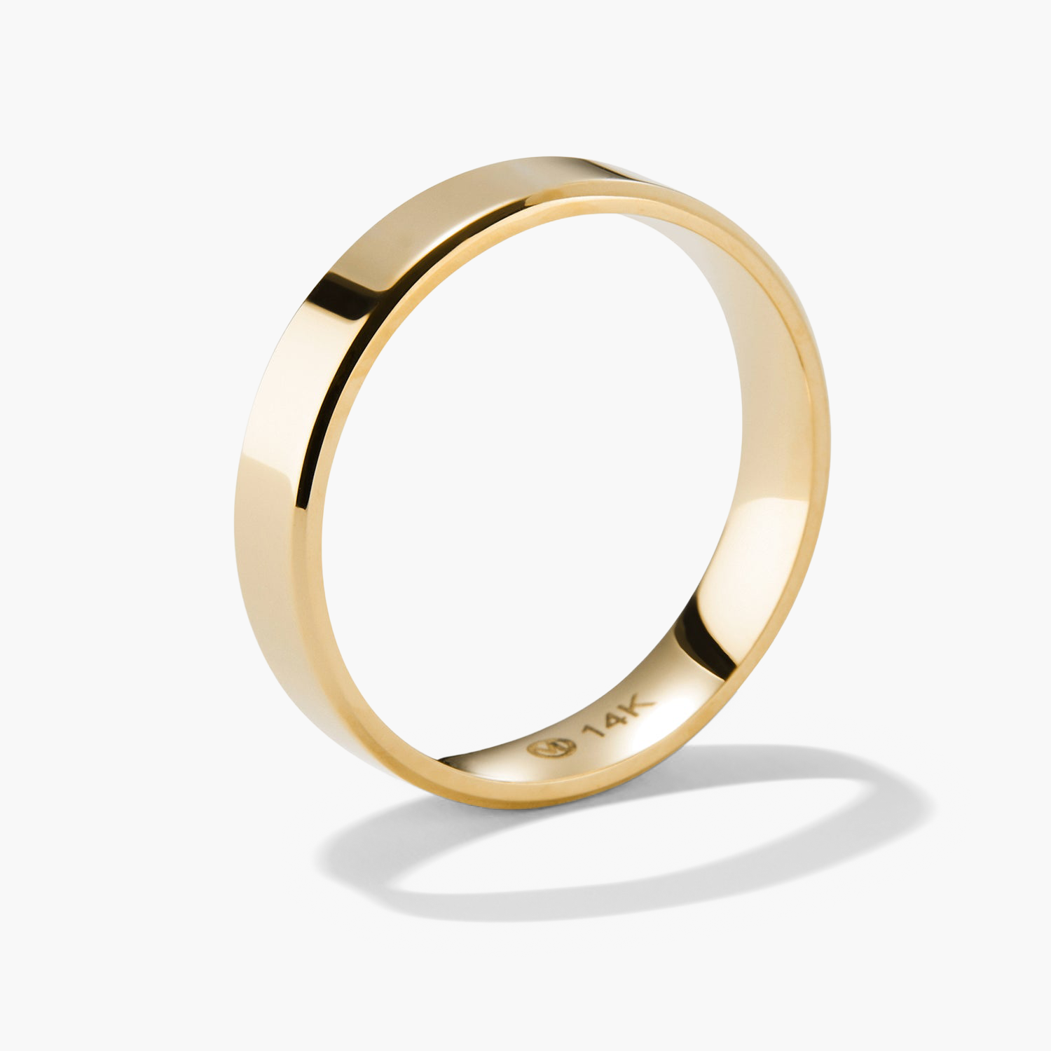 4mm Smooth Band: A close-up of a gold ring with a smooth finish, casting a shadow, highlighting its lightweight and durable design for lasting wear.