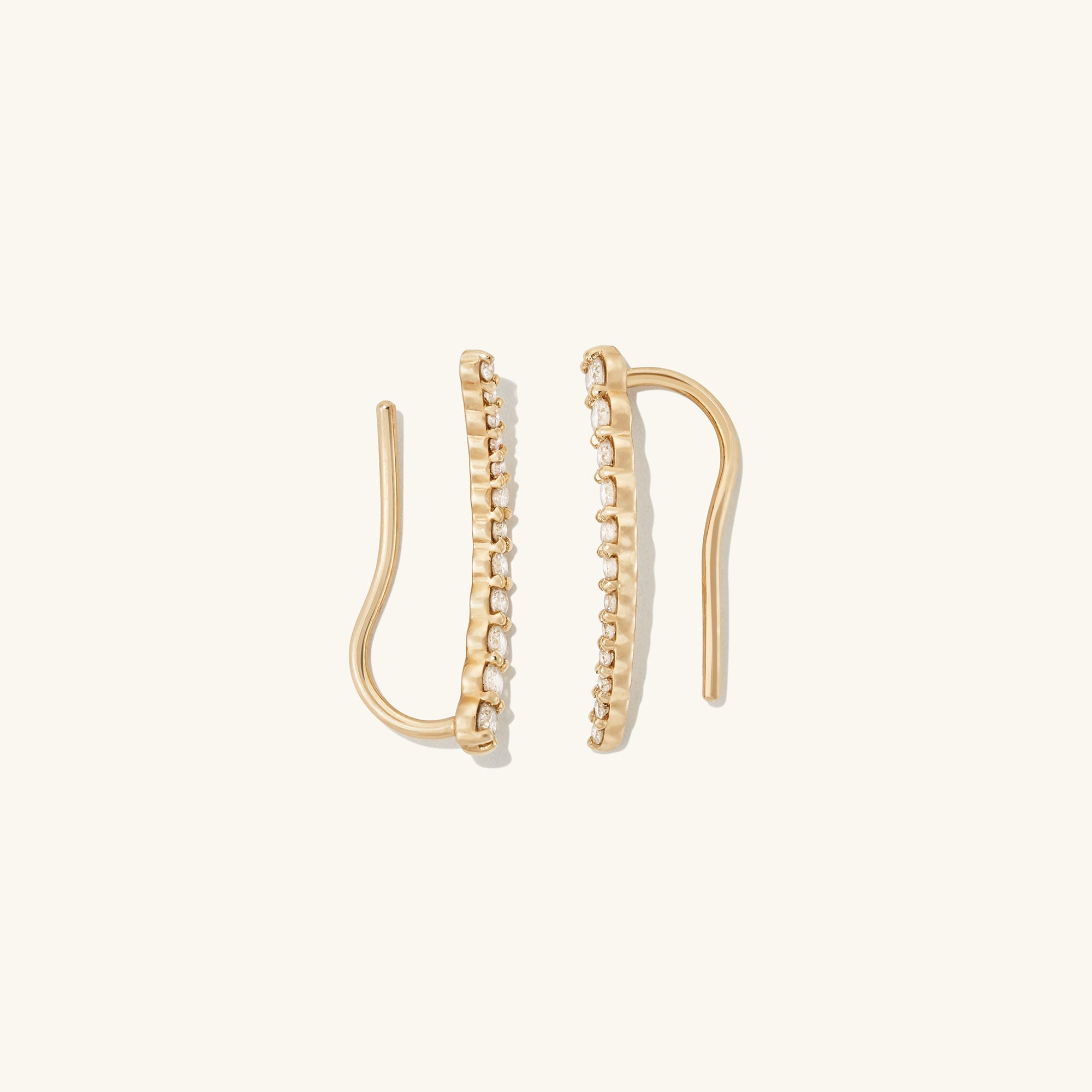 PavÃ© Diamond Climbers: A pair of 14k solid gold earrings adorned with pavÃ© diamonds designed to enhance ear real estate elegantly, suitable for single or multiple piercings.