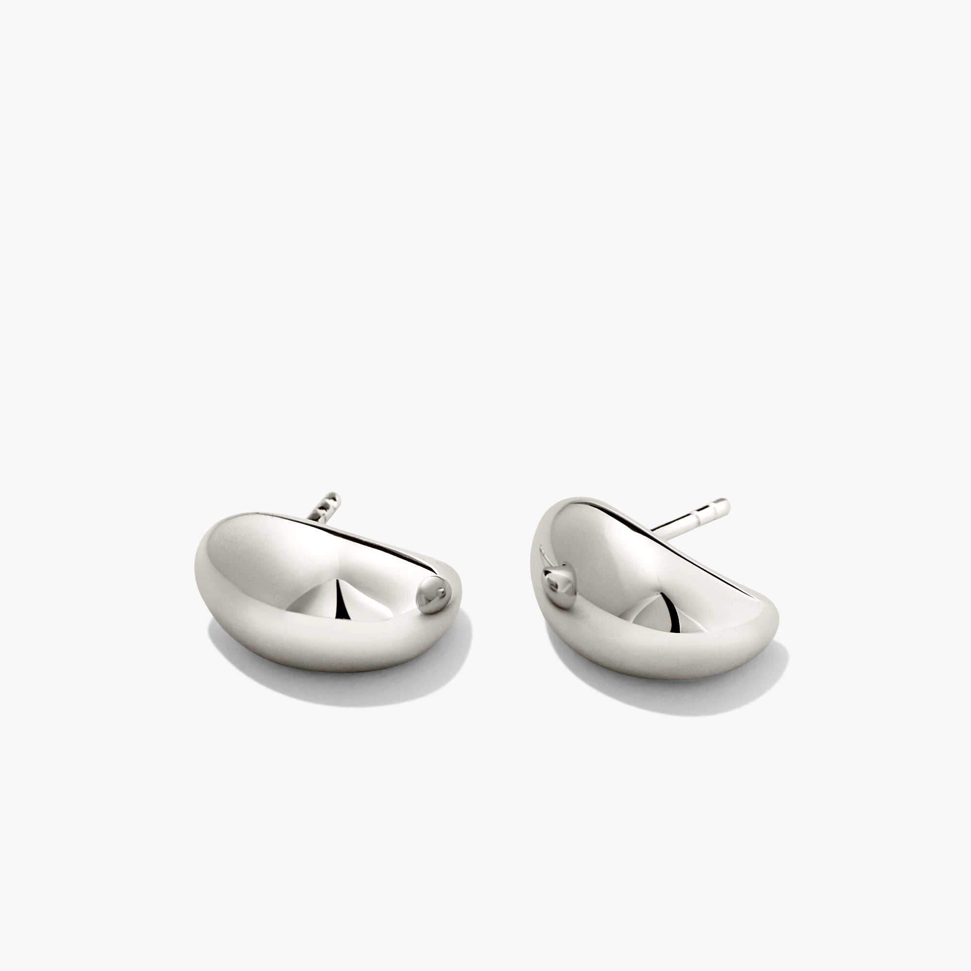 DÃ´me Huggies earrings from Mejuri, featuring sleek, sculptural design with a rounded vault, perfect for everyday wear and stacking.