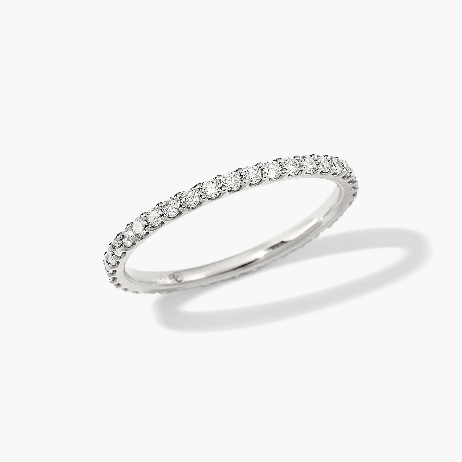 Diamond Eternity Band: A close-up of a diamond ring with hand-set diamonds in open prongs, showcasing its elegant, slim design and brilliant sparkle.