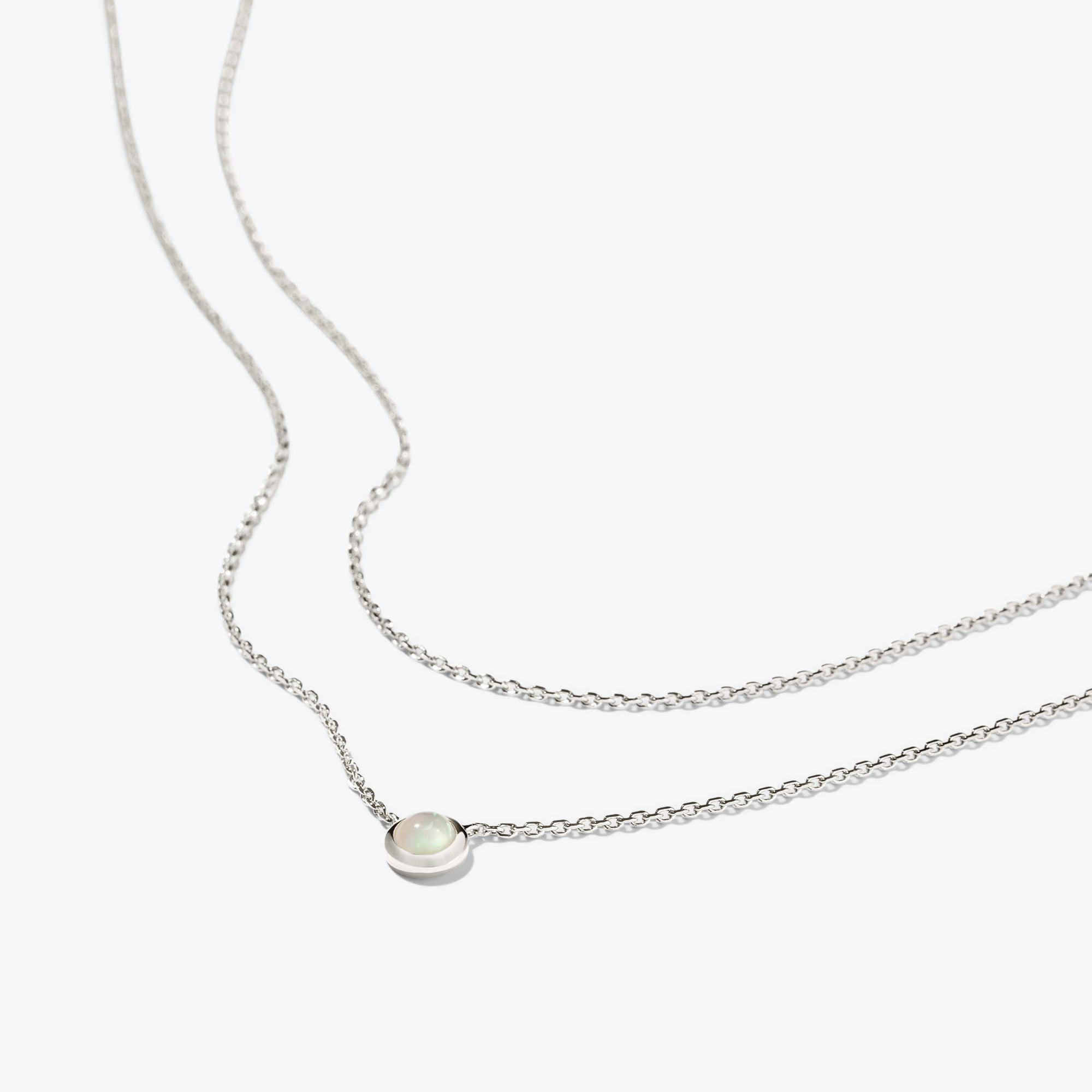 Layered Opal Necklace featuring two seamless chains and a central opal pendant, highlighted in a close-up, showcasing its elegant design and craftsmanship.