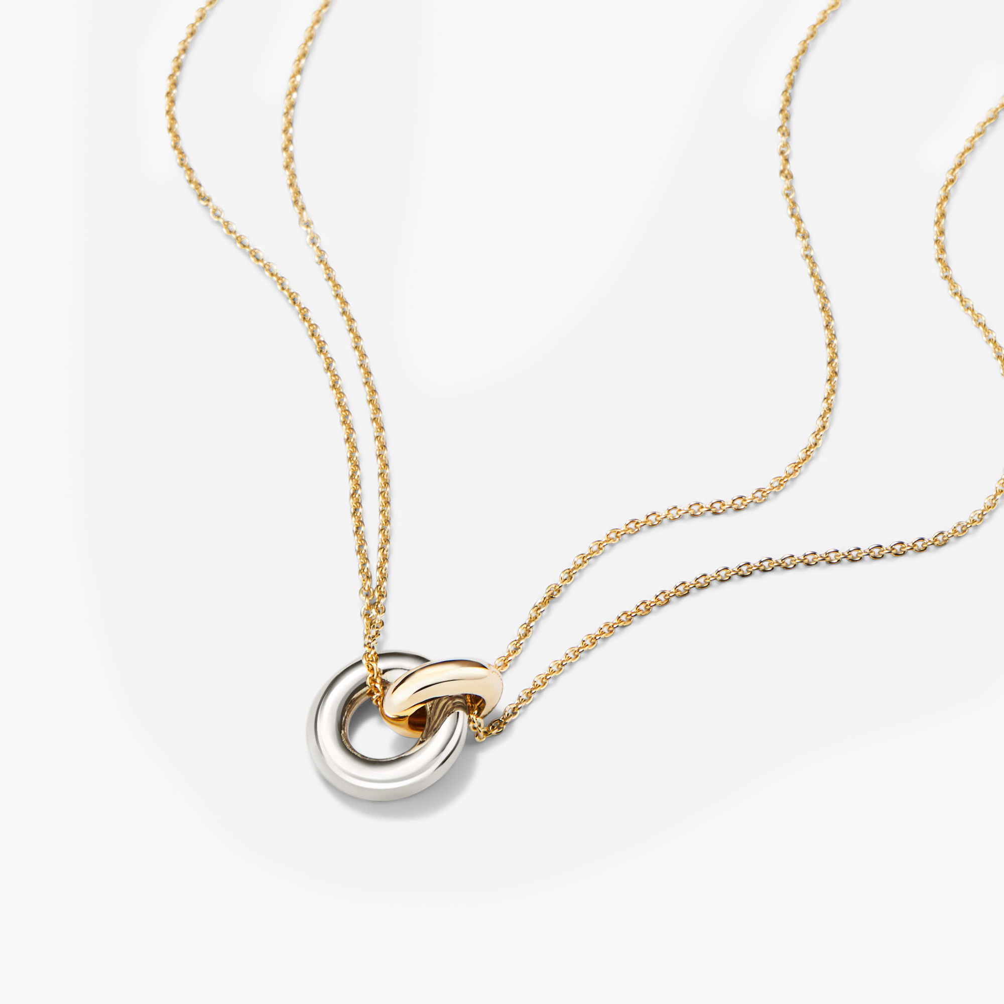 Linked Two-Tone Necklace featuring interlinked gold and silver rings on a delicate chain, symbolizing strong personal bonds. Handcrafted in sterling silver and 18k gold vermeil.