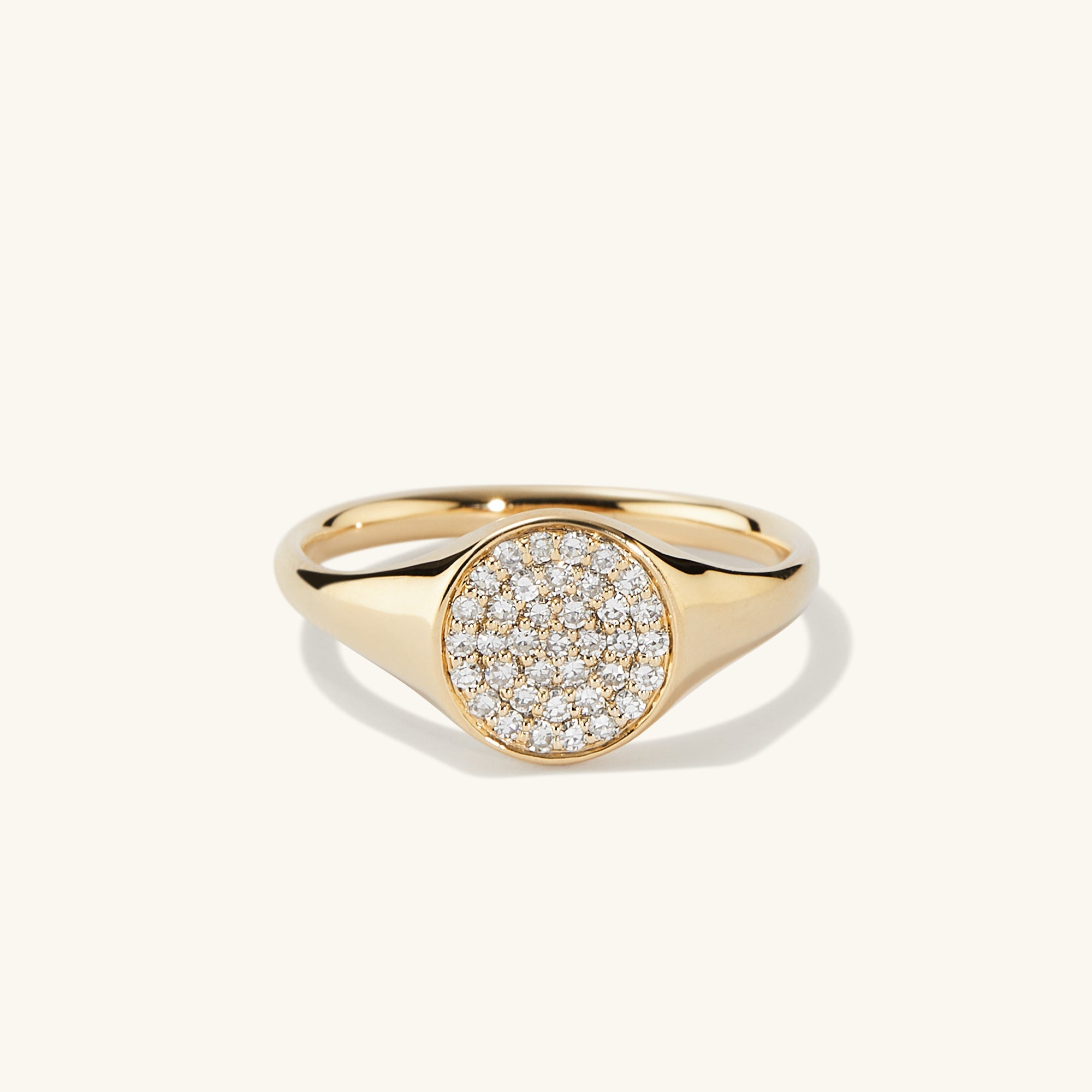 PavÃ© Diamond Signet Pinky Ring featuring a gold band with a central diamond setting, embodying elegance and sophistication in a compact design.