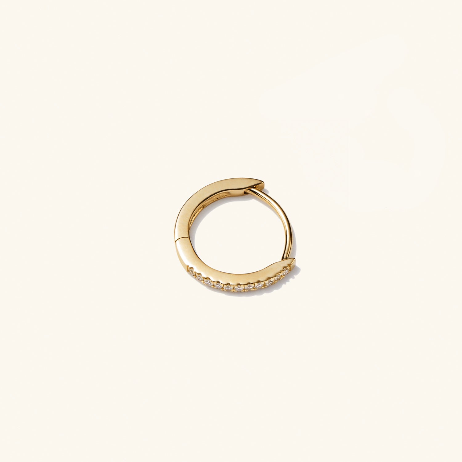 Single PavÃ© Diamond Huggie Hoop: gold earring with diamonds, handcrafted in recycled 14k solid gold, versatile for stacking with pavÃ© diamonds or worn sleek.