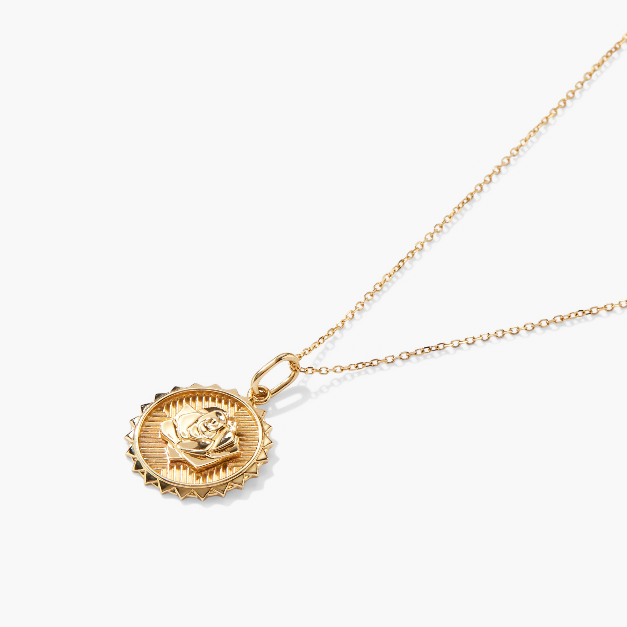 Strength: Rose Coin Charm Pendant featuring a gold medallion with an embossed rose, hanging from a delicate gold chain. Handcrafted in recycled 14k solid gold.