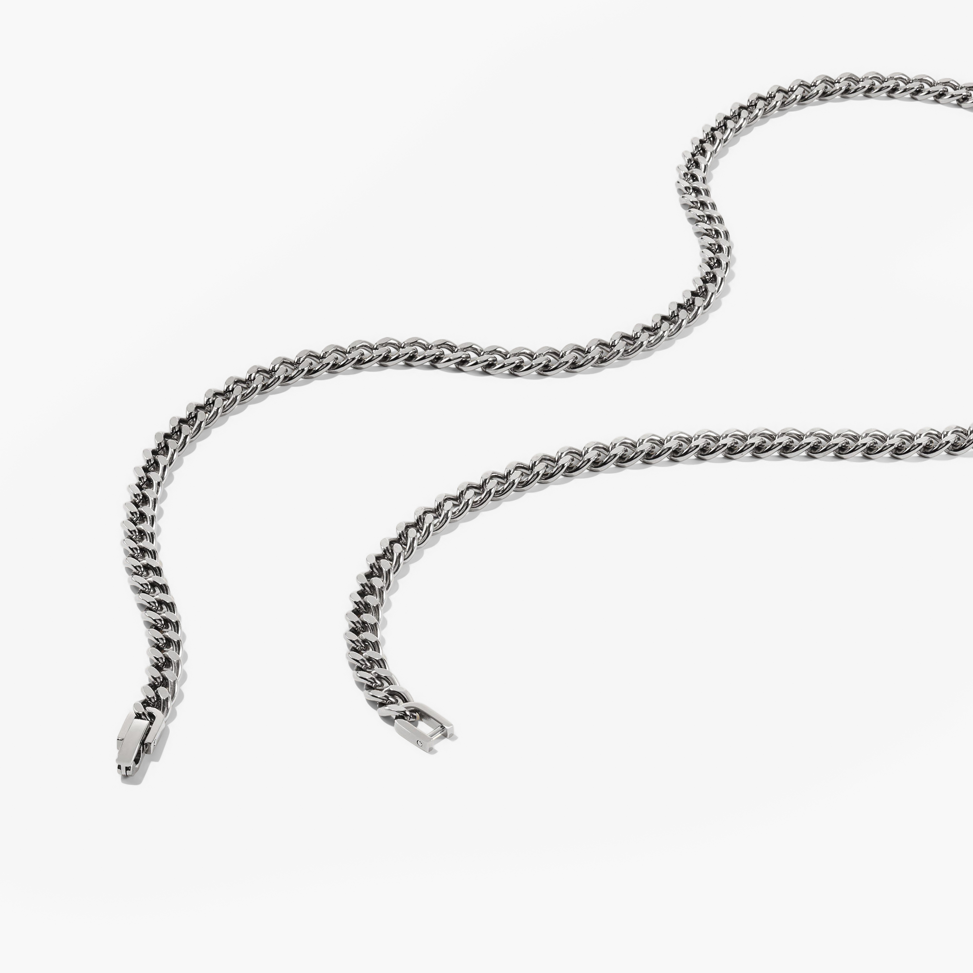 5mm Curb Chain Necklace: A close-up of a silver chain, showcasing its sleek, classic design on a white surface, perfect for everyday wear.