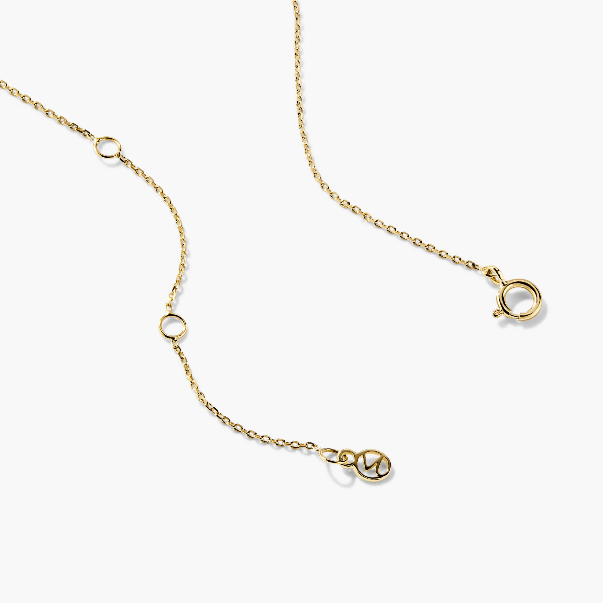 Letter Necklace featuring a gold chain with interconnected circles and rings, showcasing a prominent initial pendant at the center.