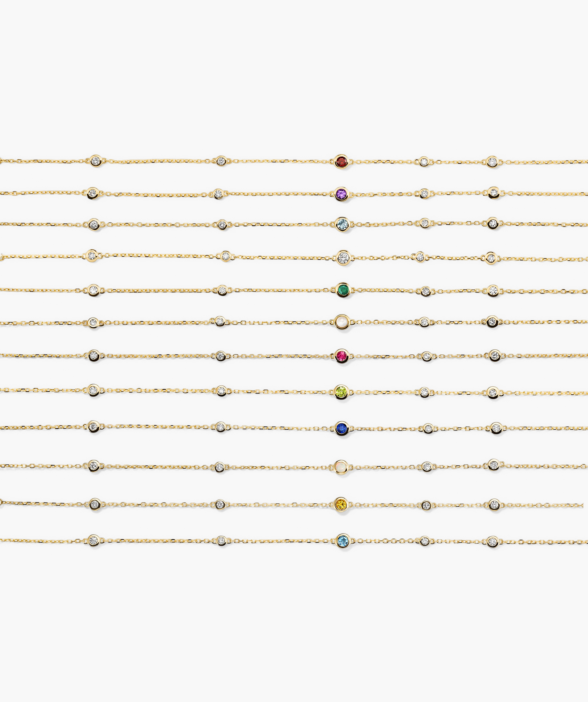 Multi Gemstone Station Bracelet: A grid of gold-chain bracelets, each with bezel-set diamonds and a central birthstone gem, showcasing twelve unique birthstone colors.