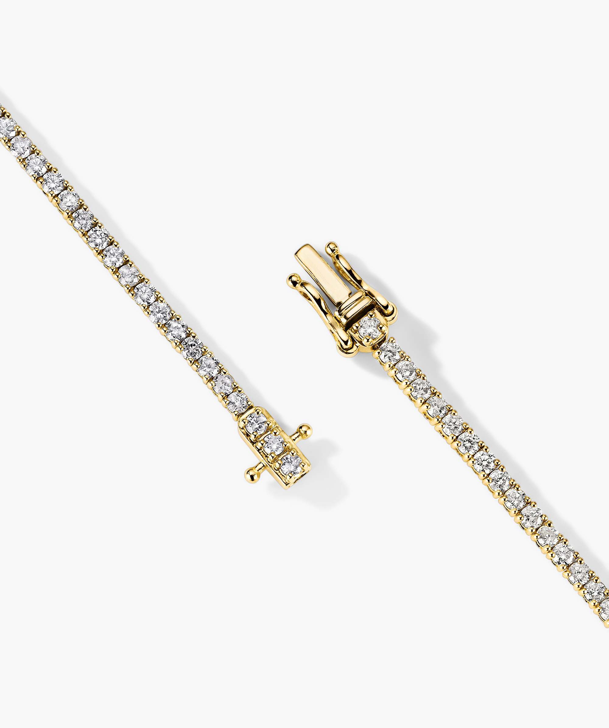 Diamond Tennis Bracelet 1.8mm: A close-up of a handcrafted 14k gold bracelet adorned with sparkling diamonds, featuring a secure clasp with safety arms.