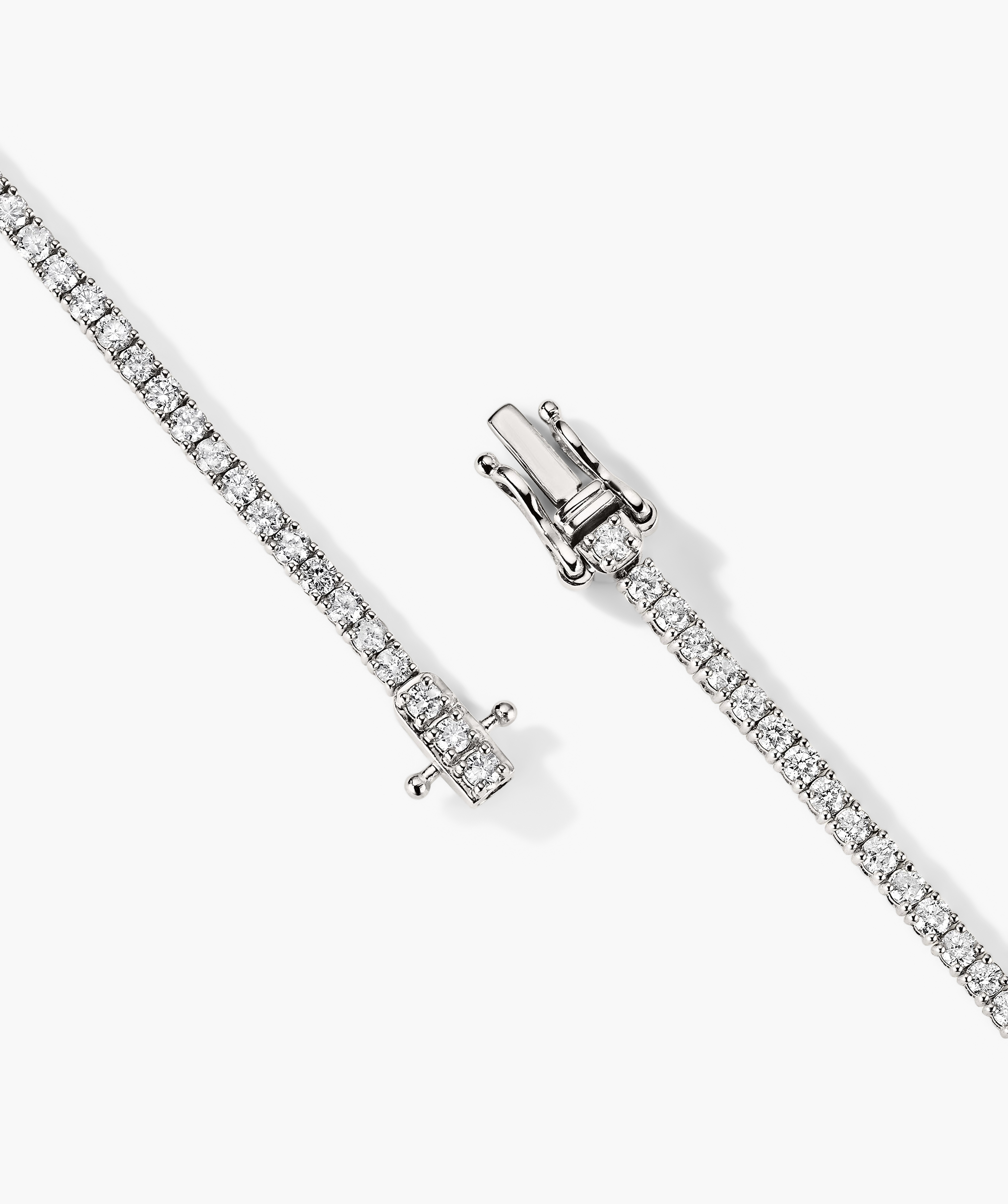 Diamond Tennis Bracelet 1.8mm: close-up of a 14k solid gold bracelet with diamonds and a silver clasp, showcasing intricate craftsmanship and secure fastening mechanism.