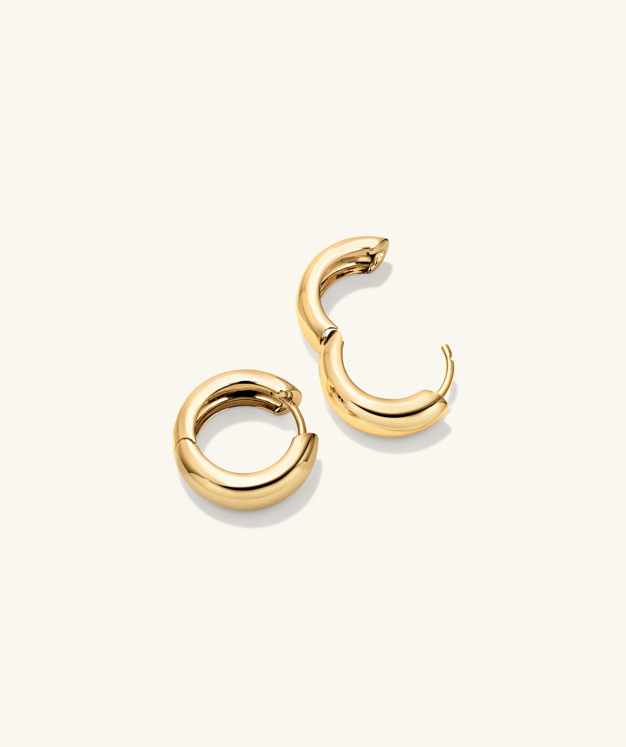 Plush Small Hoops: A pair of 14k gold handcrafted hoop earrings with a pillowy design, perfect for a bold, elegant statement.