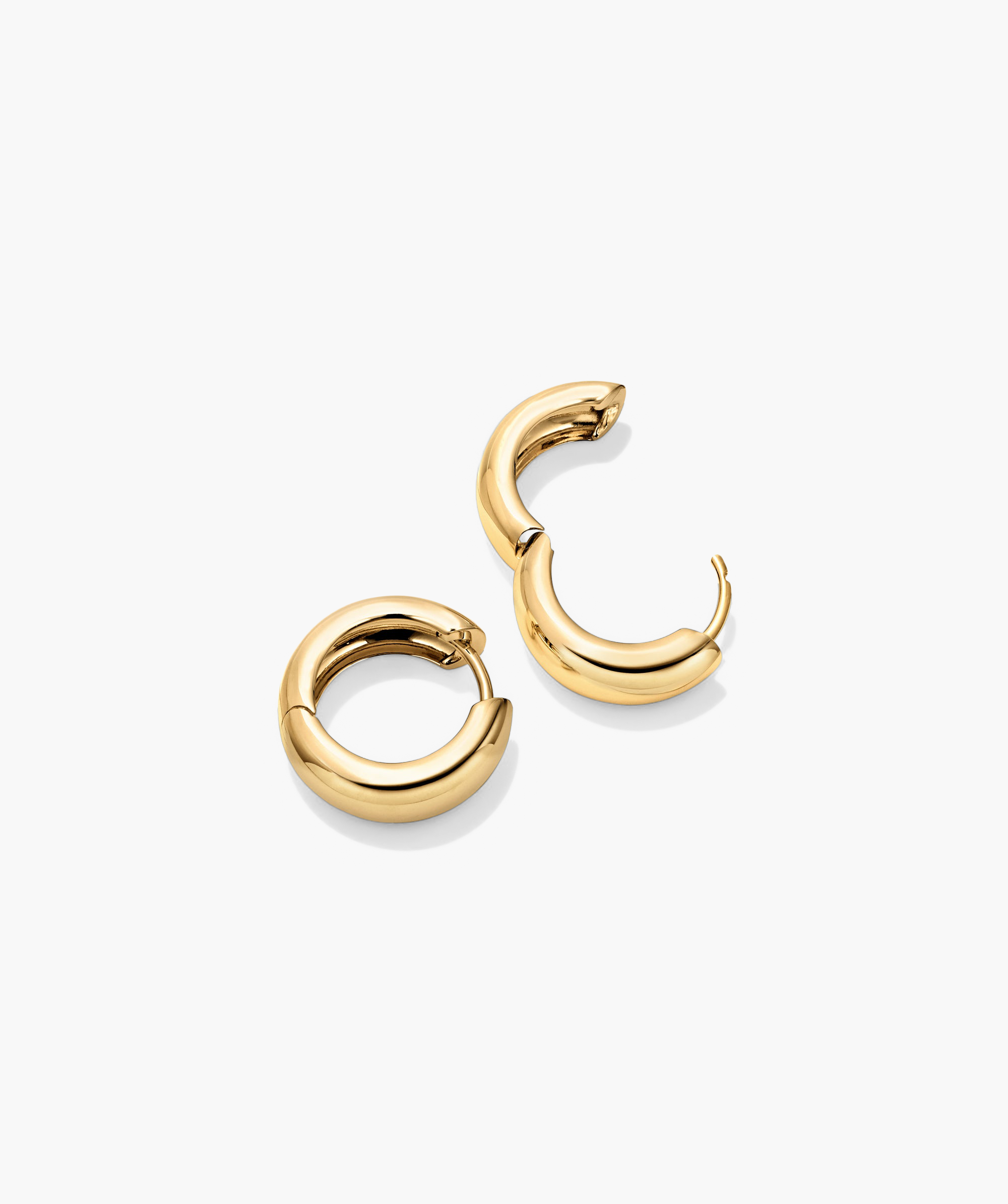 Plush Small Hoops: A pair of 14k gold handcrafted hoop earrings with a pillowy design, perfect for a bold, elegant statement.