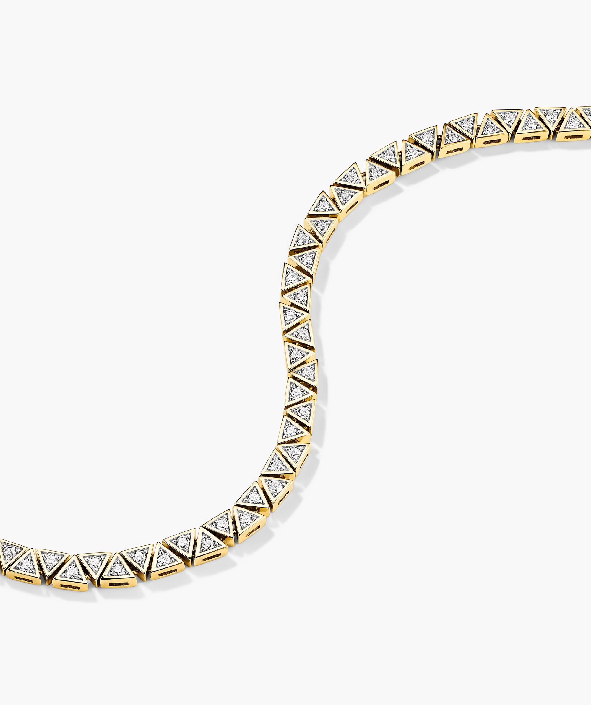 Patra Diamond Tennis Bracelet: A detailed view showcasing a gold bracelet adorned with diamonds, emphasizing its intricate craftsmanship and luxurious design.