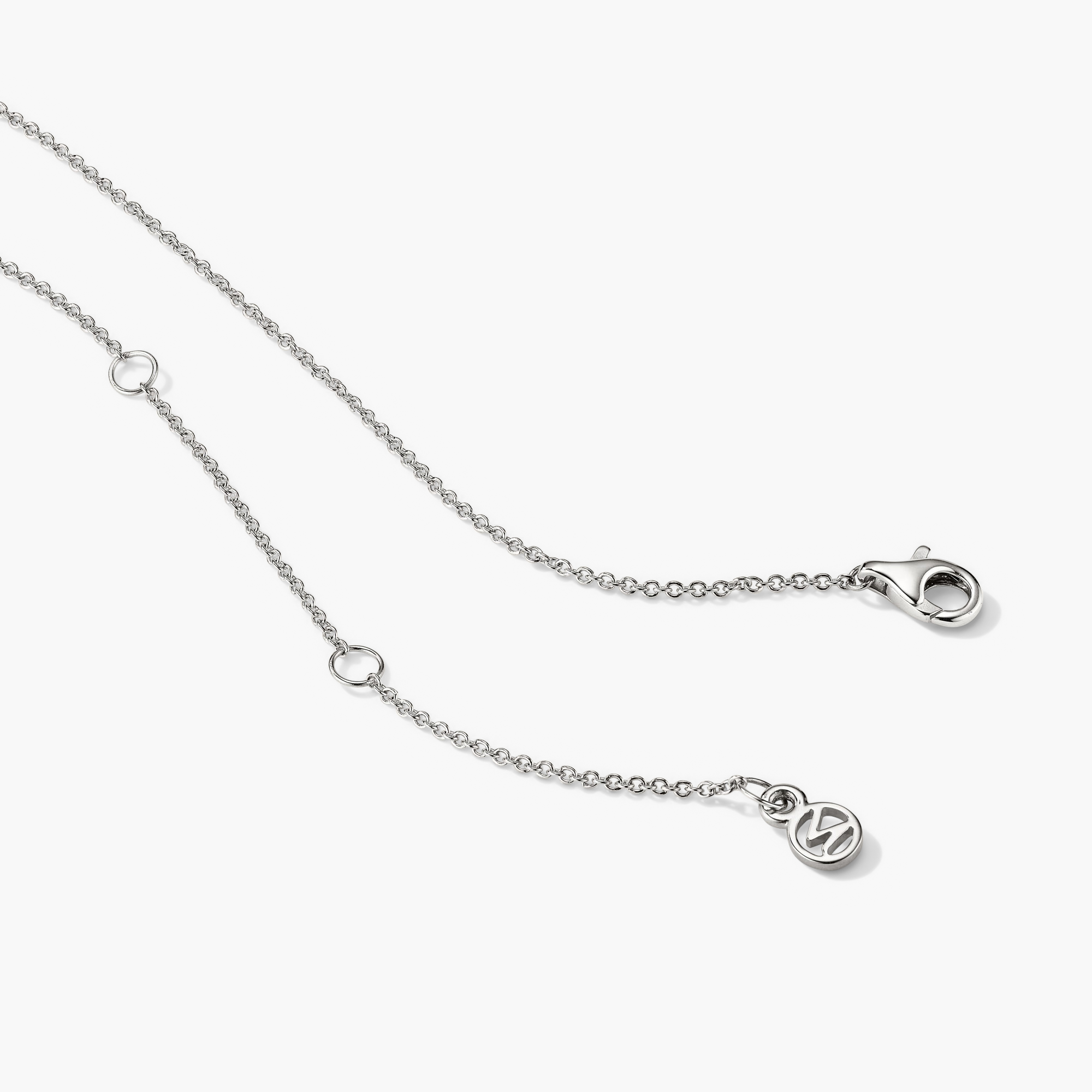 Diamond Necklace: A close-up of a silver chain with a clasp and a 14k solid gold round-cut diamond in a bezel setting.