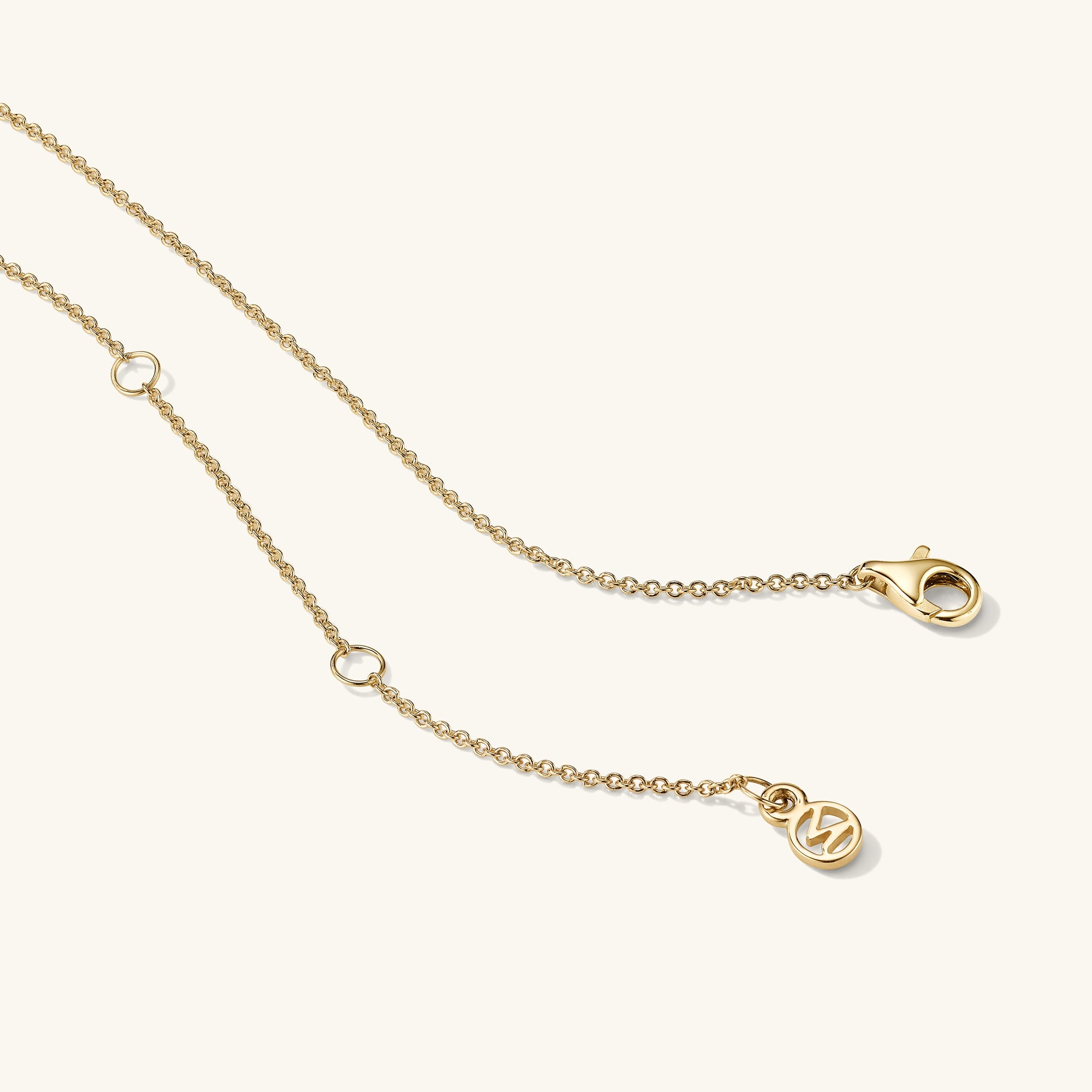 Diamond Necklace: A 14k solid gold chain with a bezel-set round cut diamond, featuring a logo clasp for a timeless and elegant look.