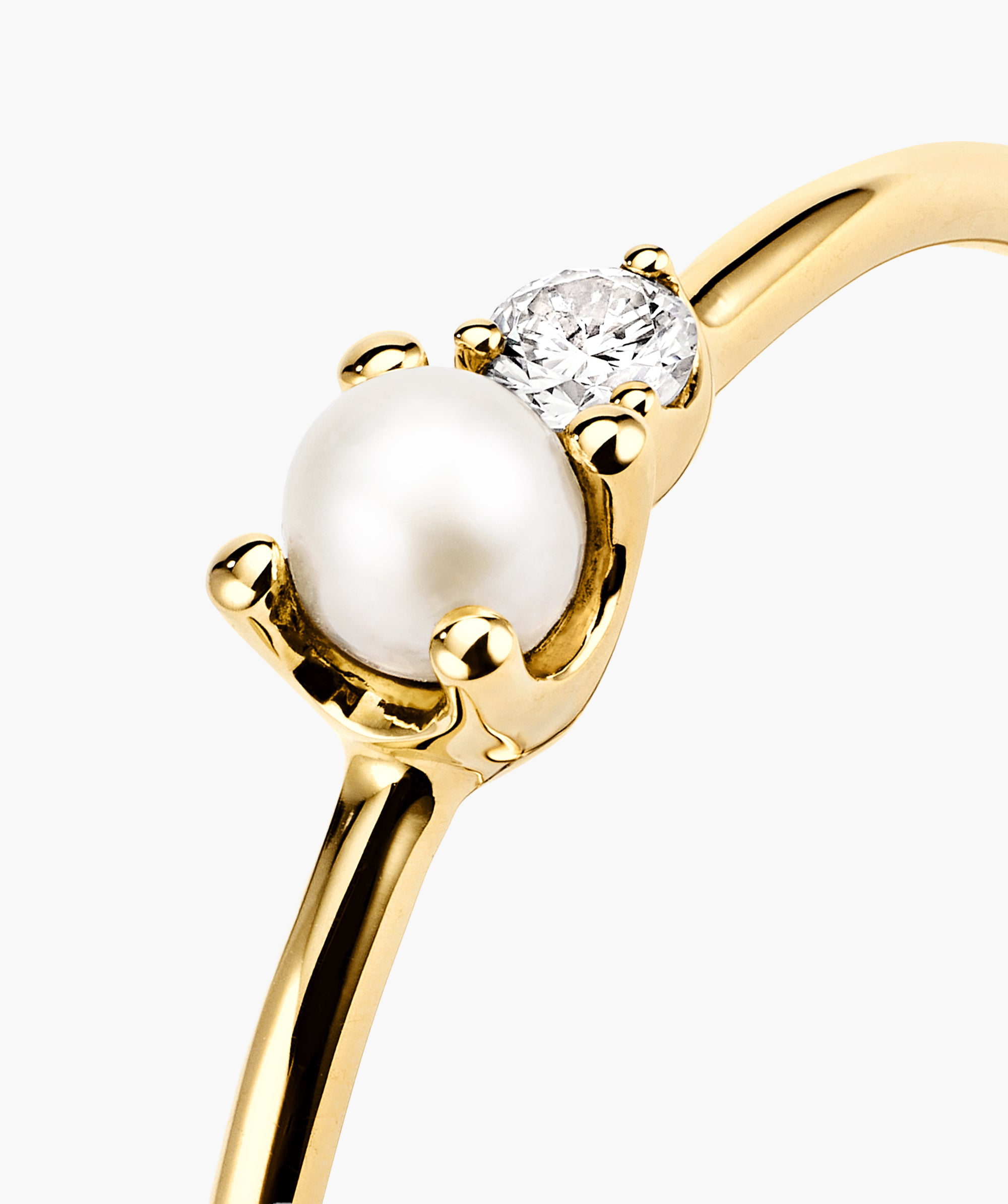Pearl and Diamond Stacker Ring: Close-up of a 14k gold ring featuring a freshwater pearl and a responsibly sourced diamond, perfect for stacking.