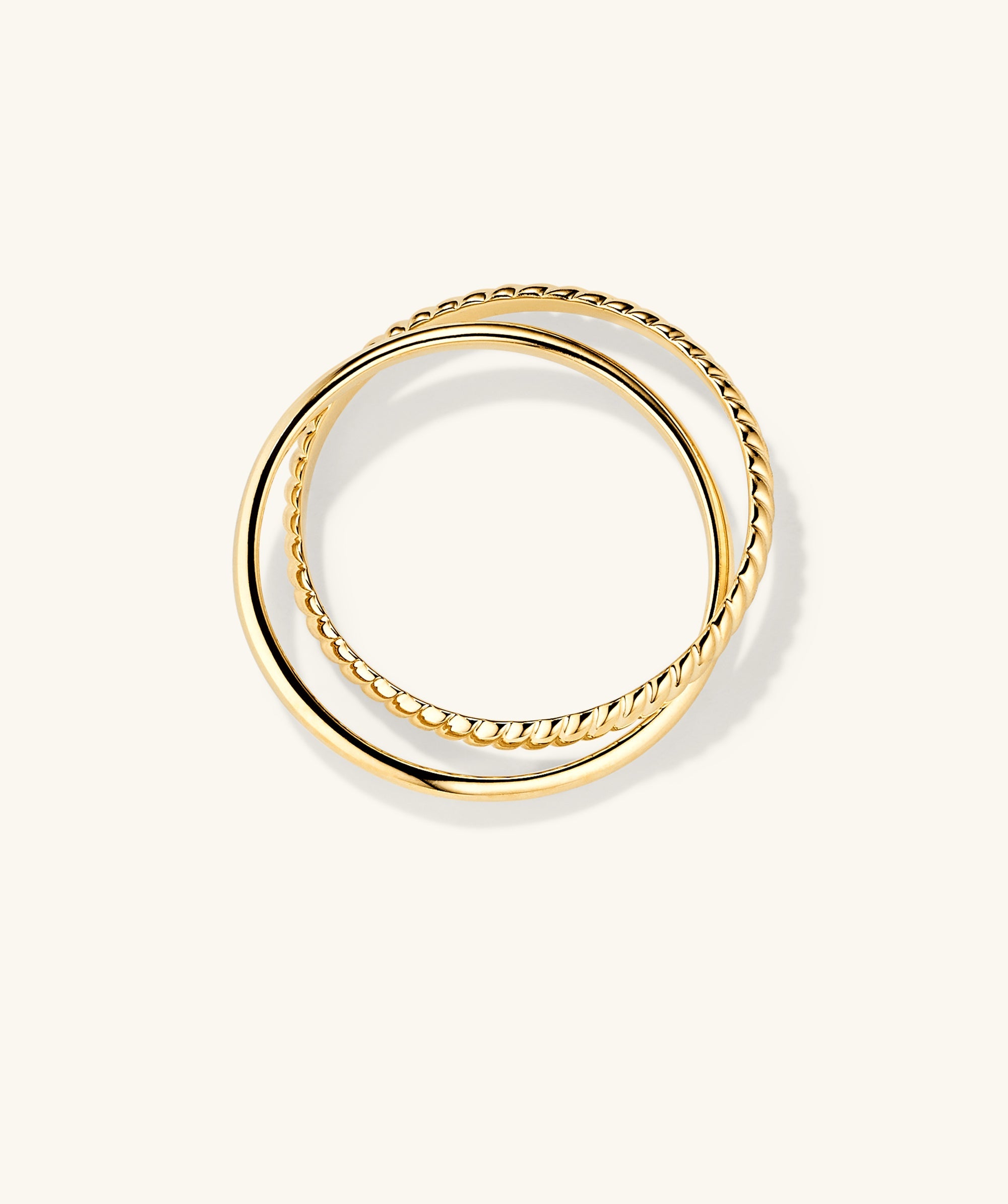 Duo Ring: A pair of handcrafted 14k solid gold rings with thicker bands, designed to twist and complement each other effortlessly.
