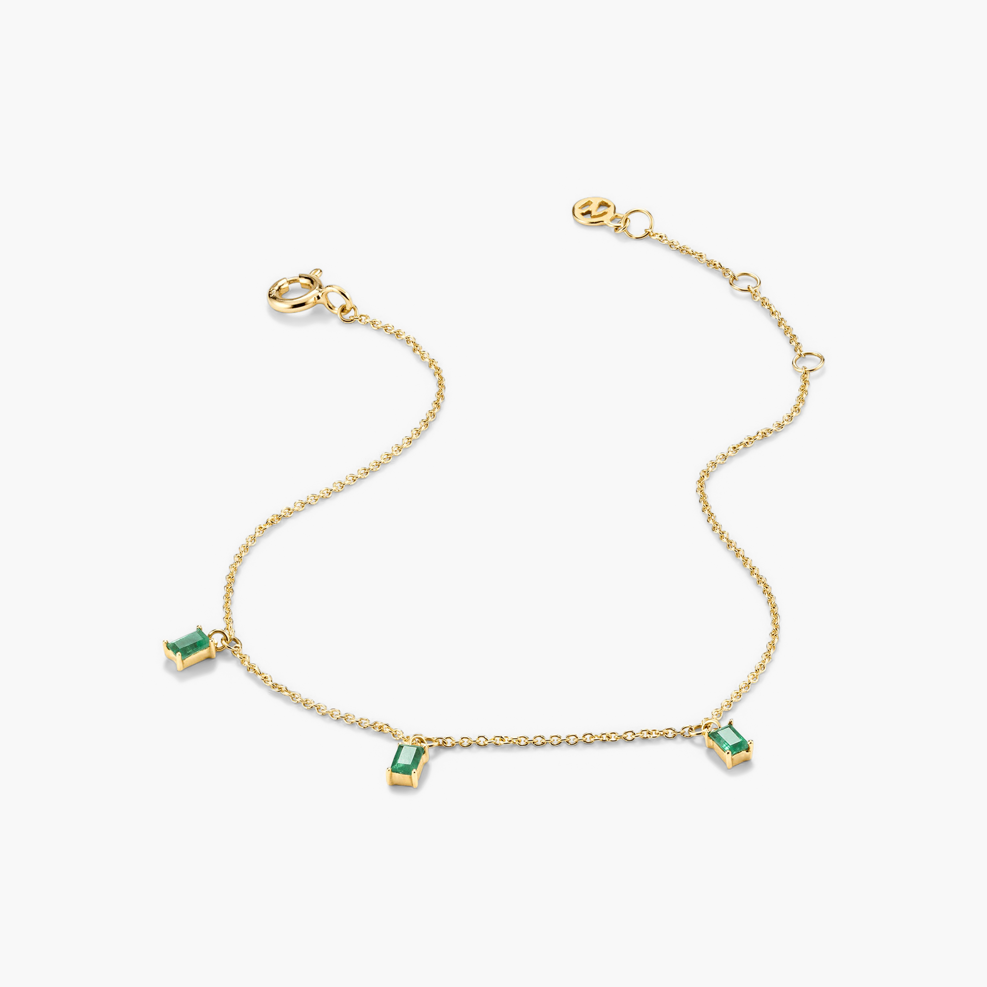 Baguette Gemstone Bracelet: A gold chain adorned with green stones, perfect for creating standout stackable looks.