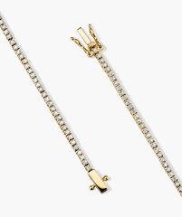Diamond Tennis Bracelet 1.3mm: A close-up of a gold chain bracelet adorned with diamonds, featuring a secure clasp with safety arms for easy wear and removal.