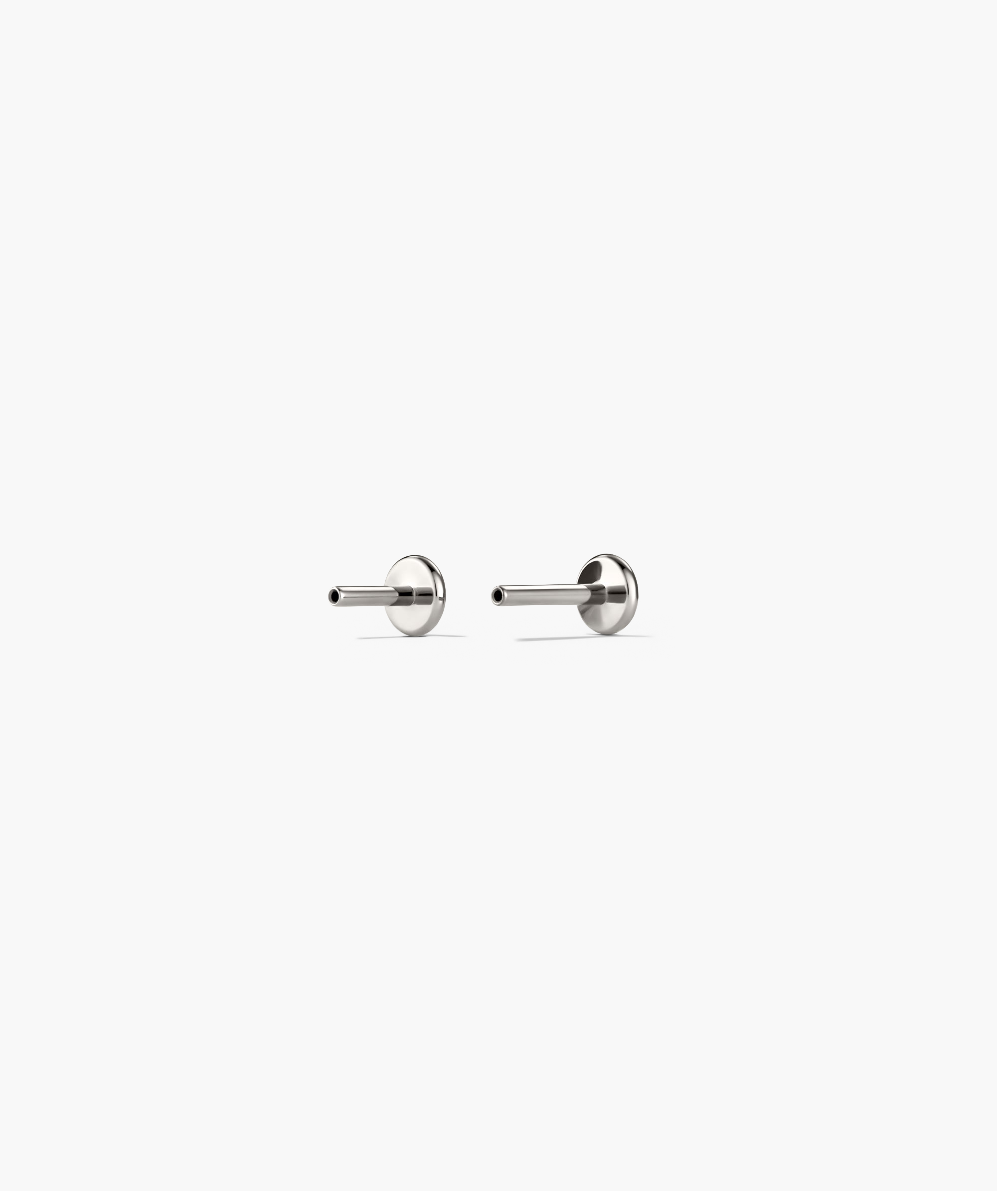 Droplet Stud earrings featuring a silver design with a stone stud and charm, resembling a droplet. Flat back for comfort and adjustable fit.