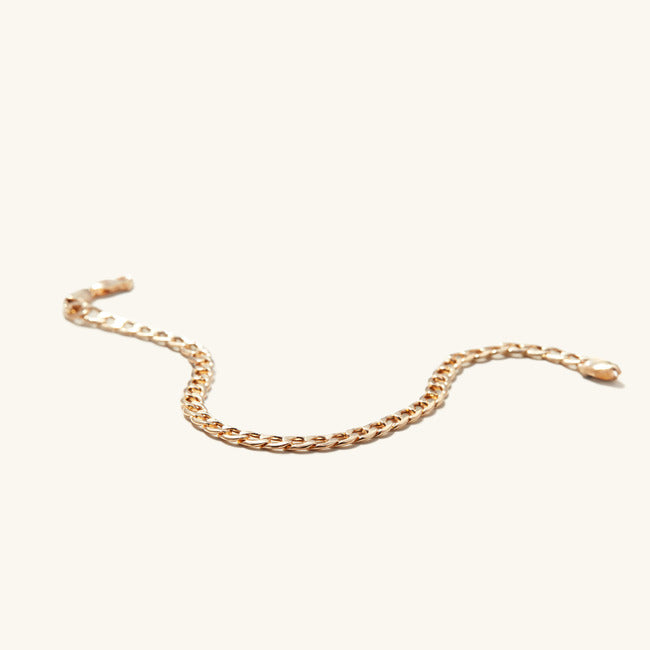 Flat Curb Chain Bracelet displayed on a neutral background, showcasing its sleek, continuous gold design that effortlessly complements any look.
