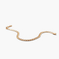 Flat Curb Chain Bracelet displayed on a neutral background, showcasing its sleek, continuous gold design that effortlessly complements any look.