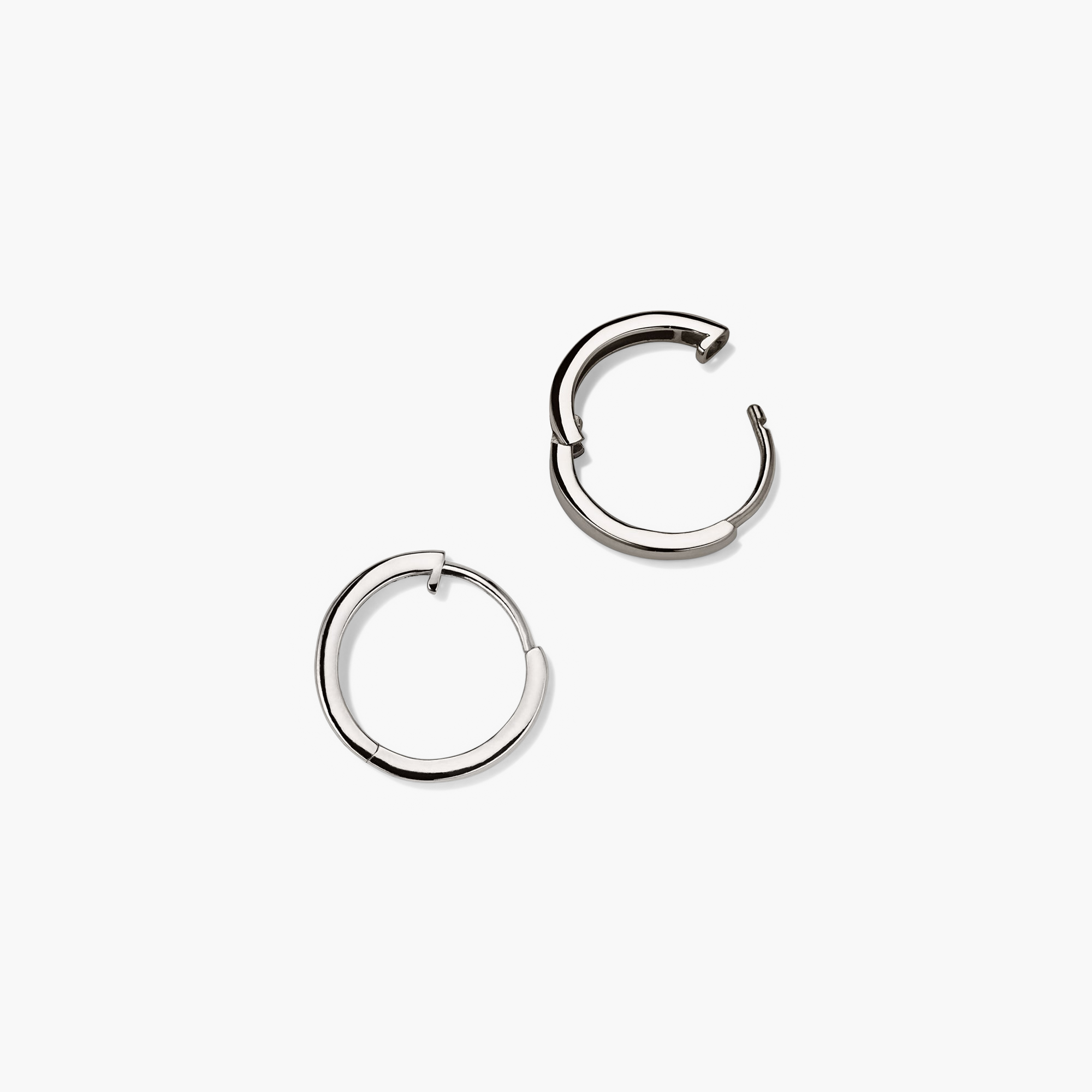 Easy Huggie Hoops: A pair of silver hoop earrings with a sleek, hollowed 14k gold design and clicker closure for comfort and security.