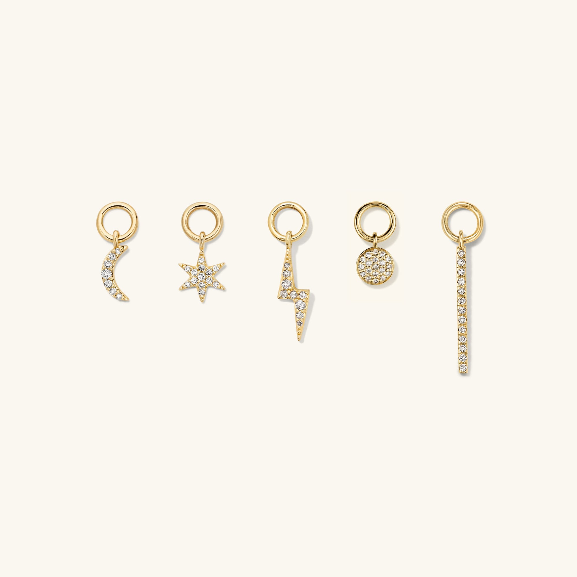 Single PavÃ© Diamond Star Hoop Charm displayed among other gold jewelry, showcasing a gold star adorned with diamonds designed to enhance and personalize hoop earrings.