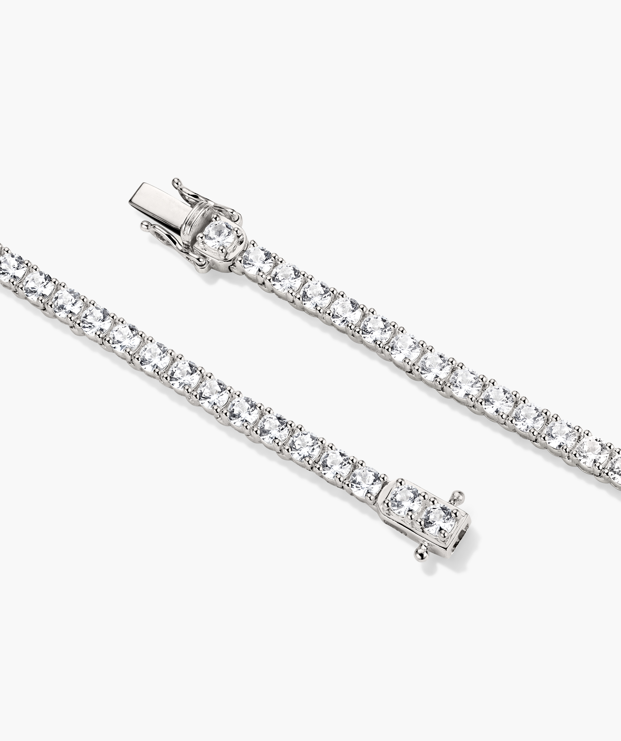 Lab Grown Sapphire Tennis Bracelet featuring prong-set, clear lab-grown sapphires in sterling silver, with a secure box clasp and safety catches.