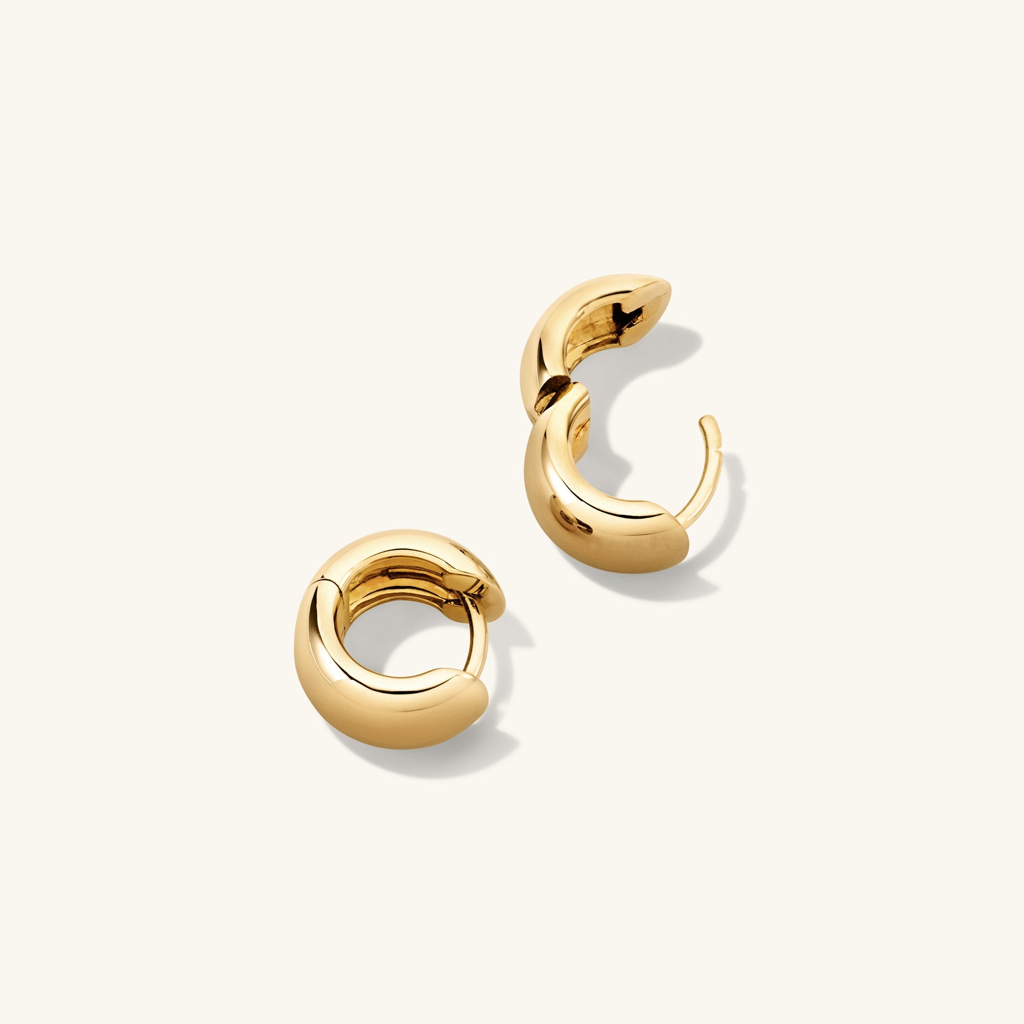 Chunky Huggie Hoops: A pair of gold hoop earrings with a pillowy design and clicker closure for comfort and security.