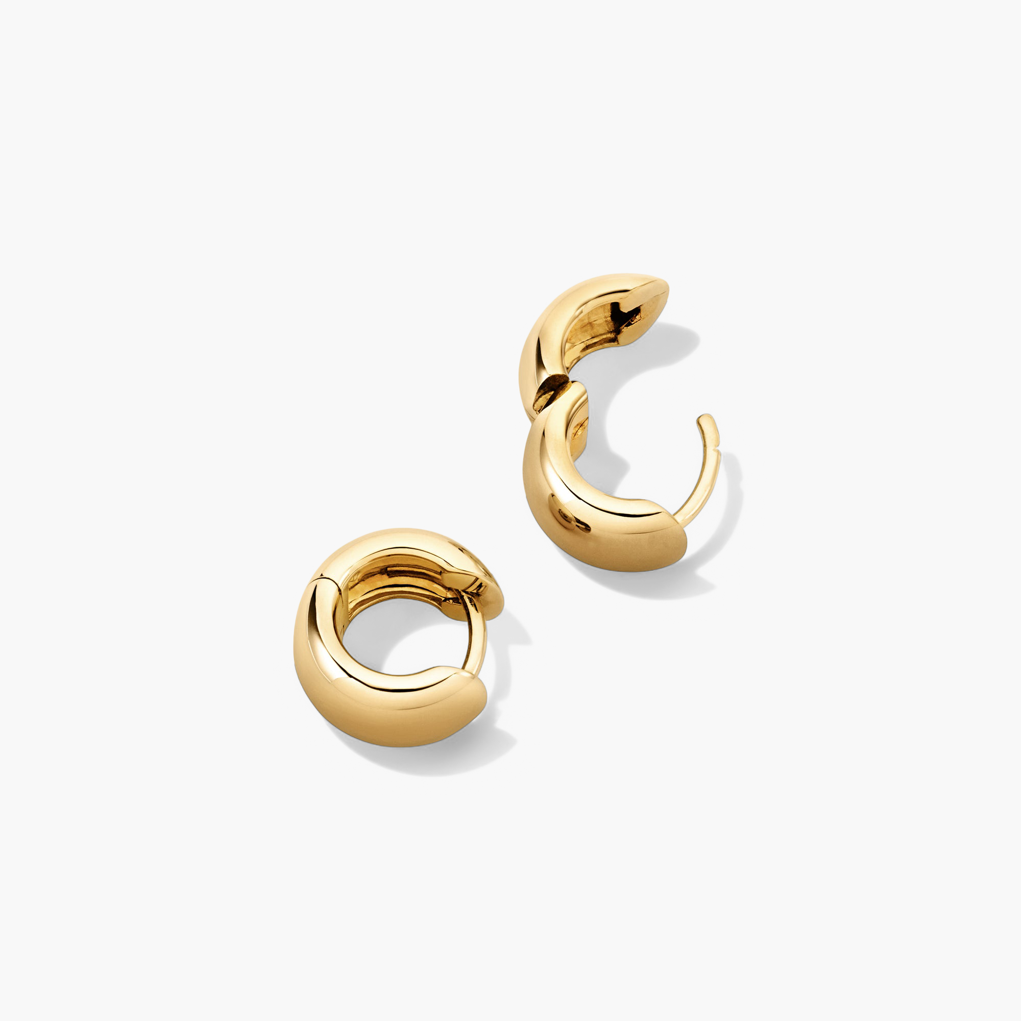 Chunky Huggie Hoops: A pair of gold hoop earrings with a pillowy design and clicker closure for comfort and security.