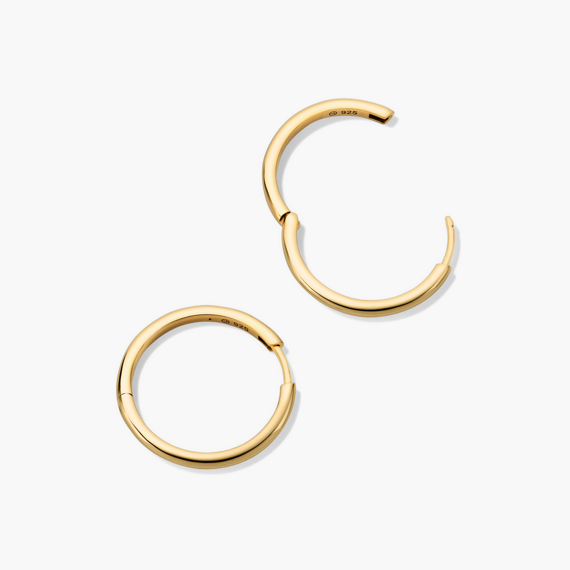 Tube Large Hoops: A pair of bold, lightweight gold hoop earrings with a clicker closure for comfort and security.