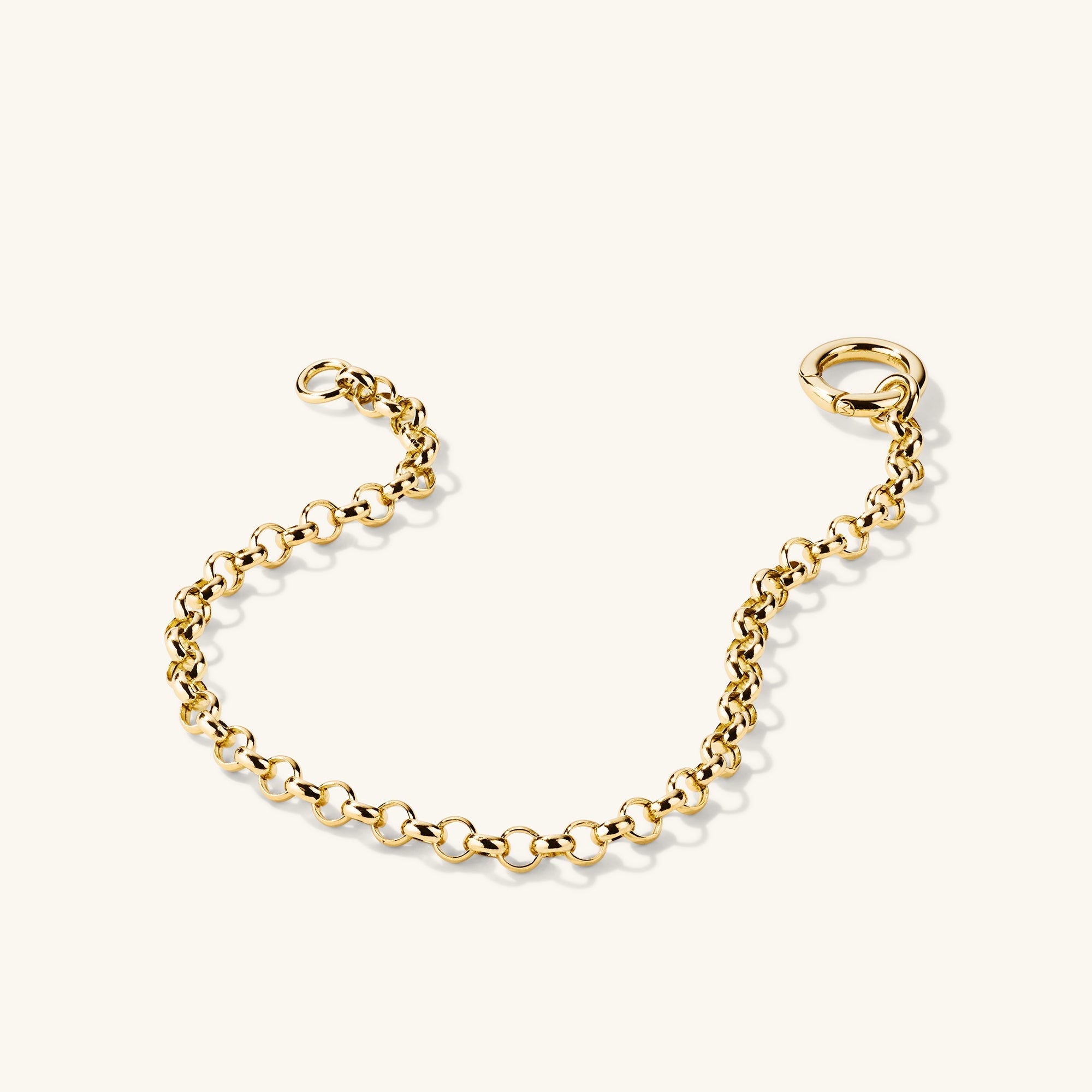 Rolo Chain Charm Bracelet: A 14k solid gold handcrafted bracelet featuring a Stacker Clasp for layering three charms, showcased on a white background.