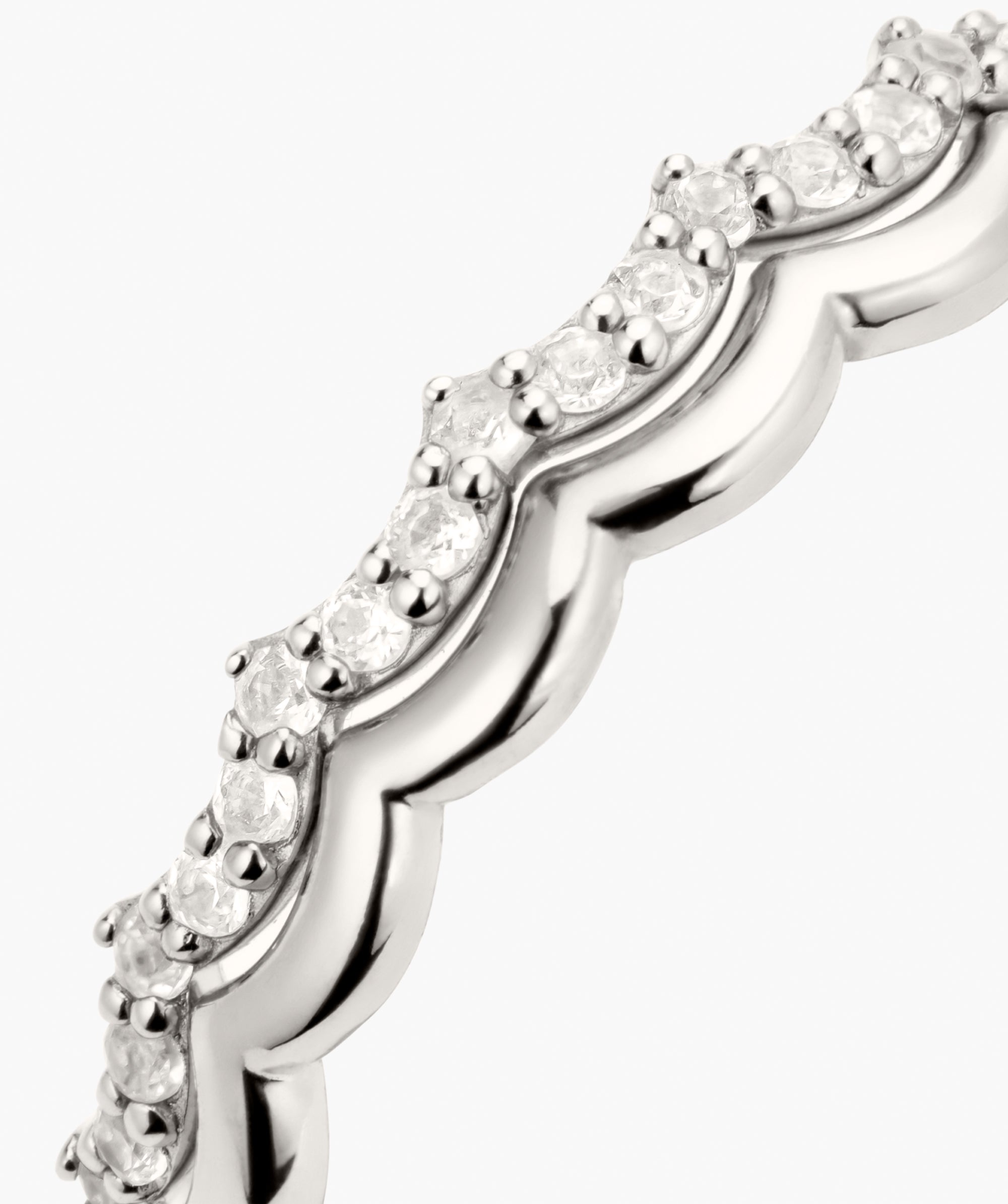 Slim Charlotte Stacker Set: Close-up of a scalloped metal band with prong-set diamonds, designed for stacking with sapphire accents for added flair.