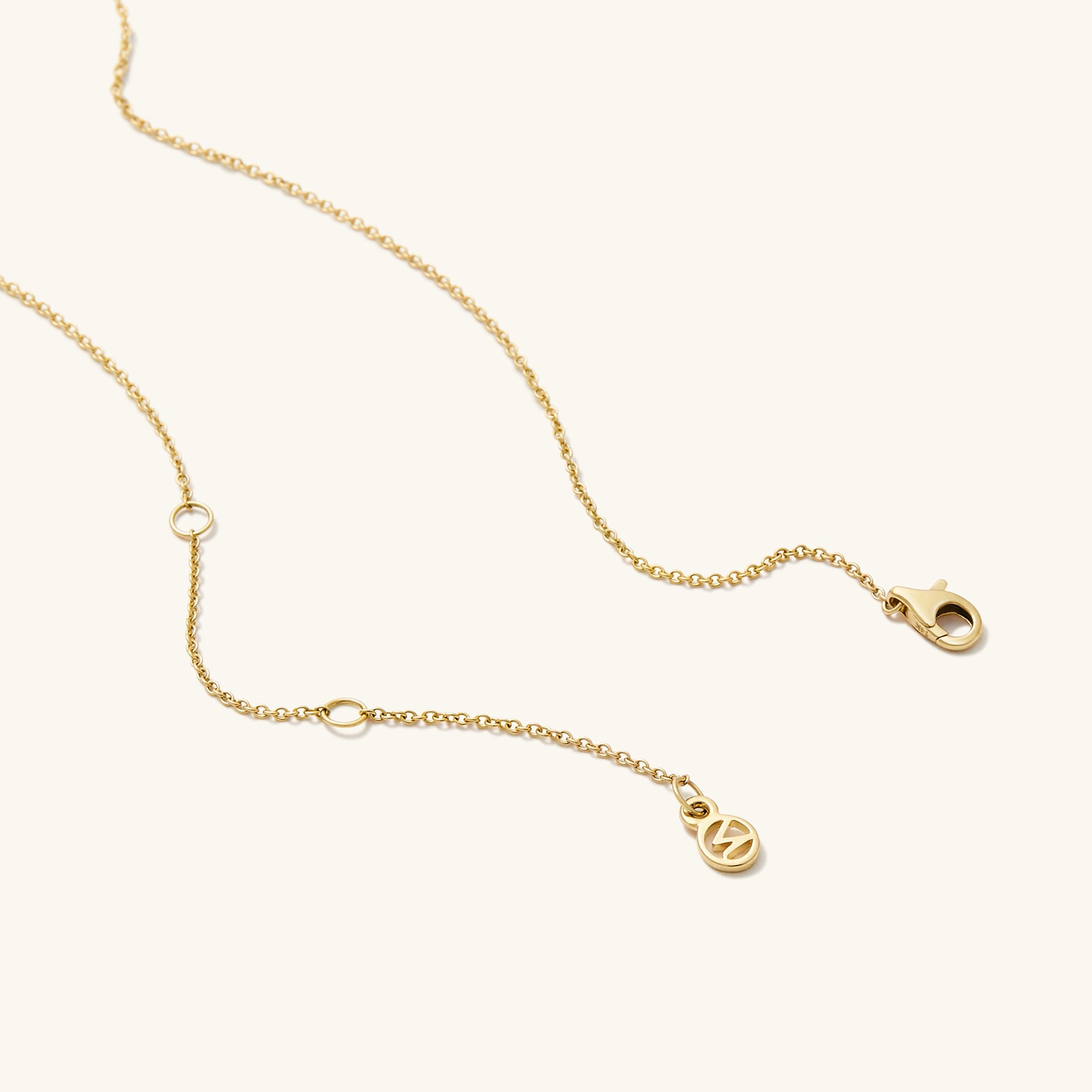 Zodiac Pendant Necklace with a gold chain and constellation-themed spinning disk set with white sapphire gemstones.